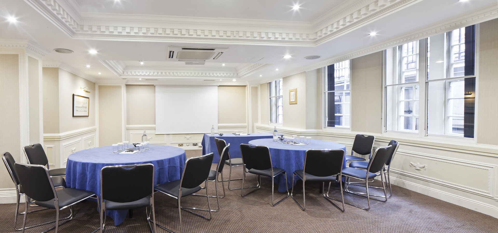 Cavendish Suite meeting room with blue tables, ideal for workshops and conferences.