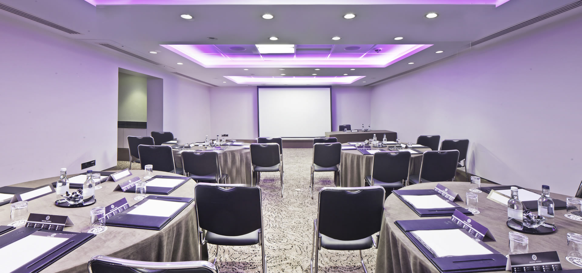 Titchfield Suite meeting room with round tables, ideal for professional events and networking.