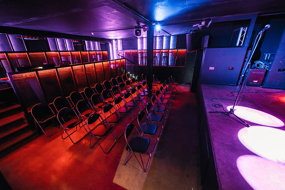 Intimate event space in Peckham Audio with stage and seating for presentations or performances.
