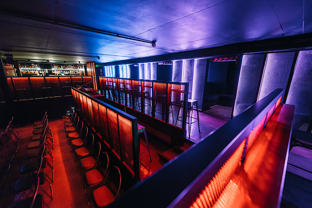 Stylish event space in Peckham Audio with vibrant lighting, ideal for presentations and performances.