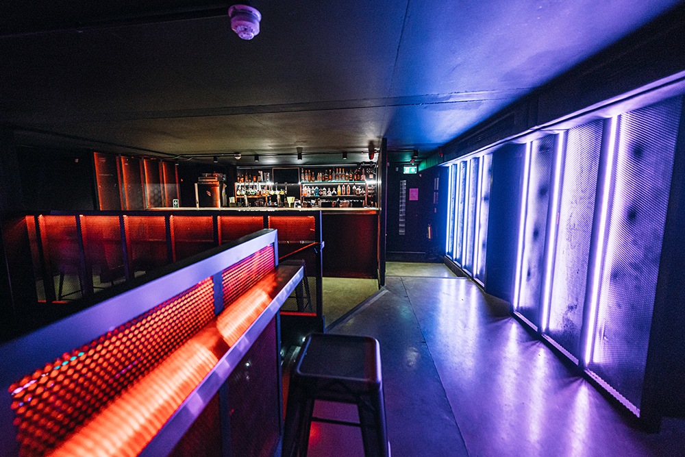 Modern event space with sleek bar and vibrant lighting in Peckham Audio.