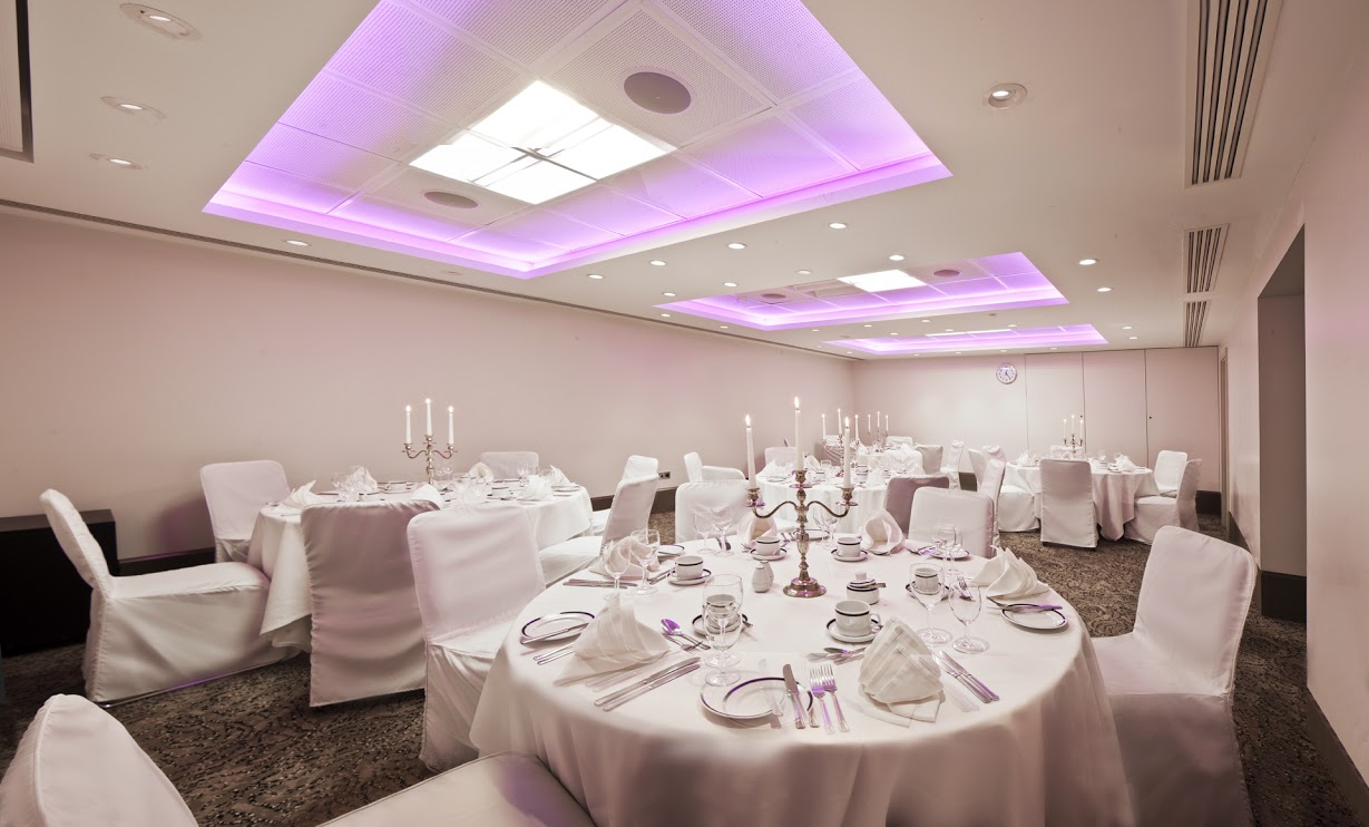 Elegant Langham Suite banquet room with soft purple lighting for upscale events.