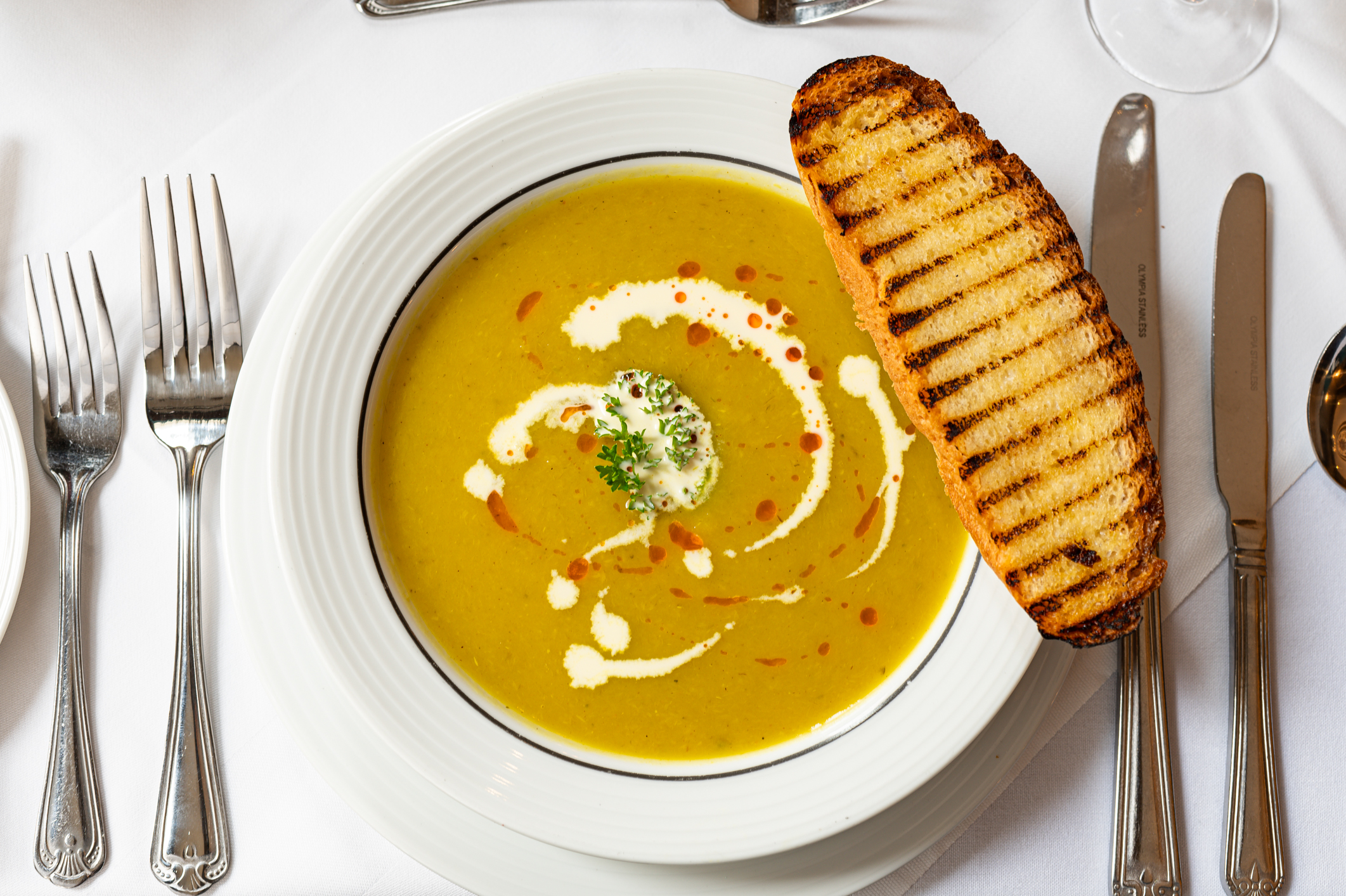 Bowl of soup with cream and herbs at Gem Strathmore Hotel for networking lunch.