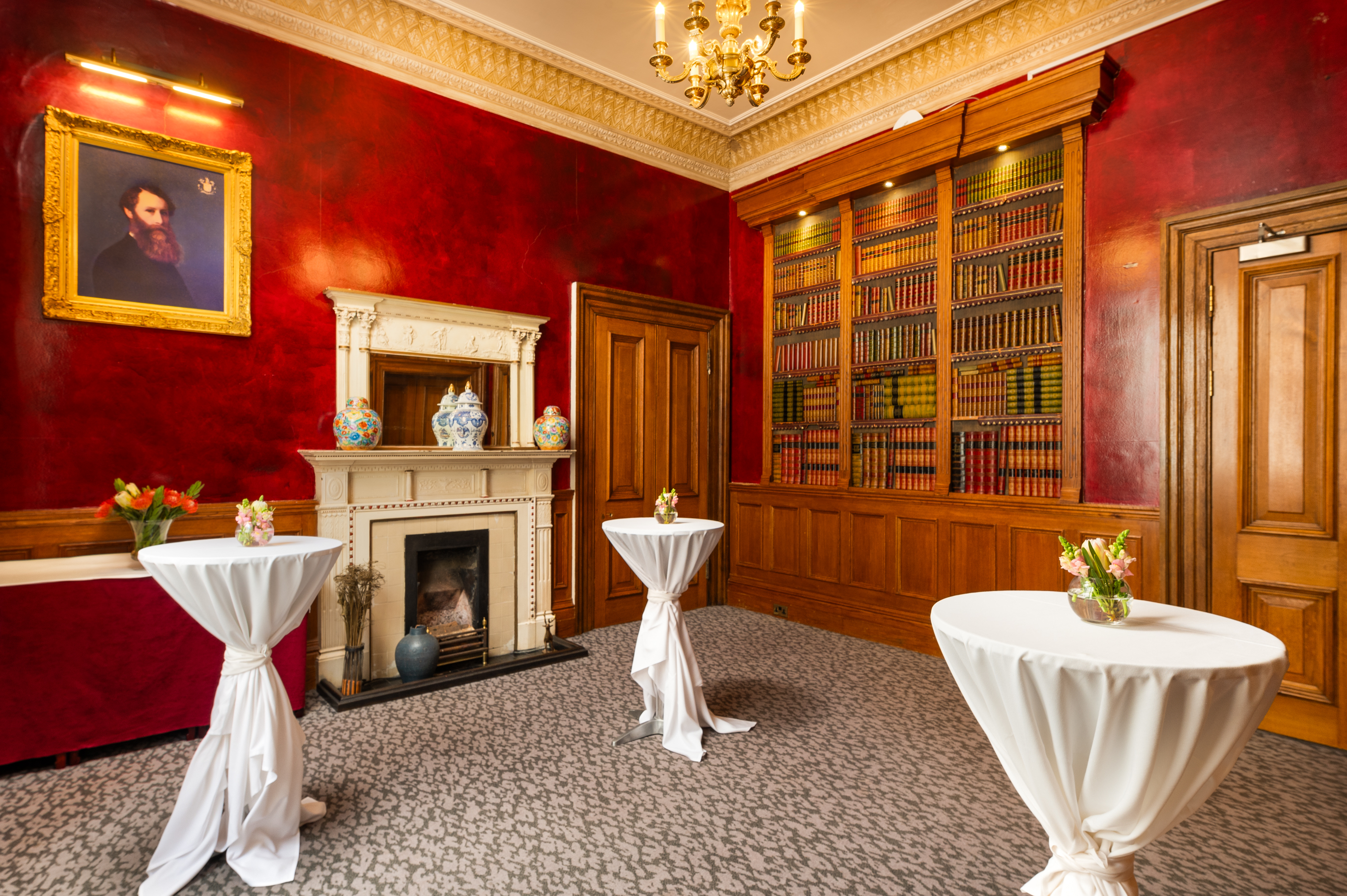 Elegant meeting space with red walls, ideal for networking events at Gem Strathmore Hotel.