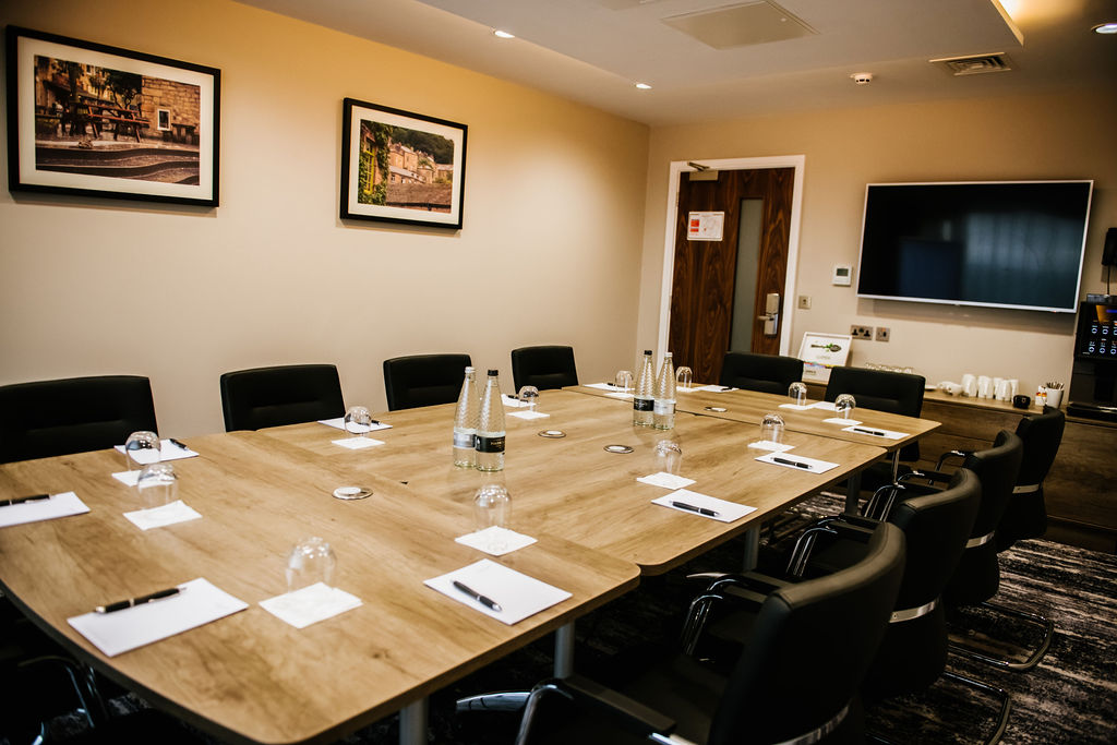Woodland Boardroom at Crow Wood Hotel, featuring a large wooden table for meetings.