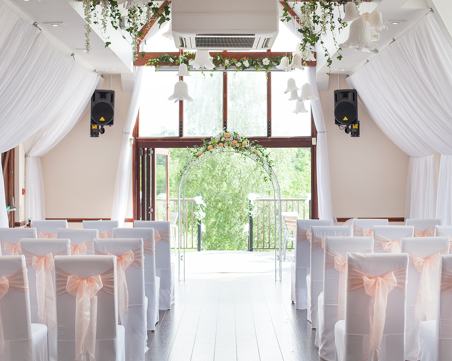 Elegant wedding venue with soft drapery and floral accents in Golf World Stansted.