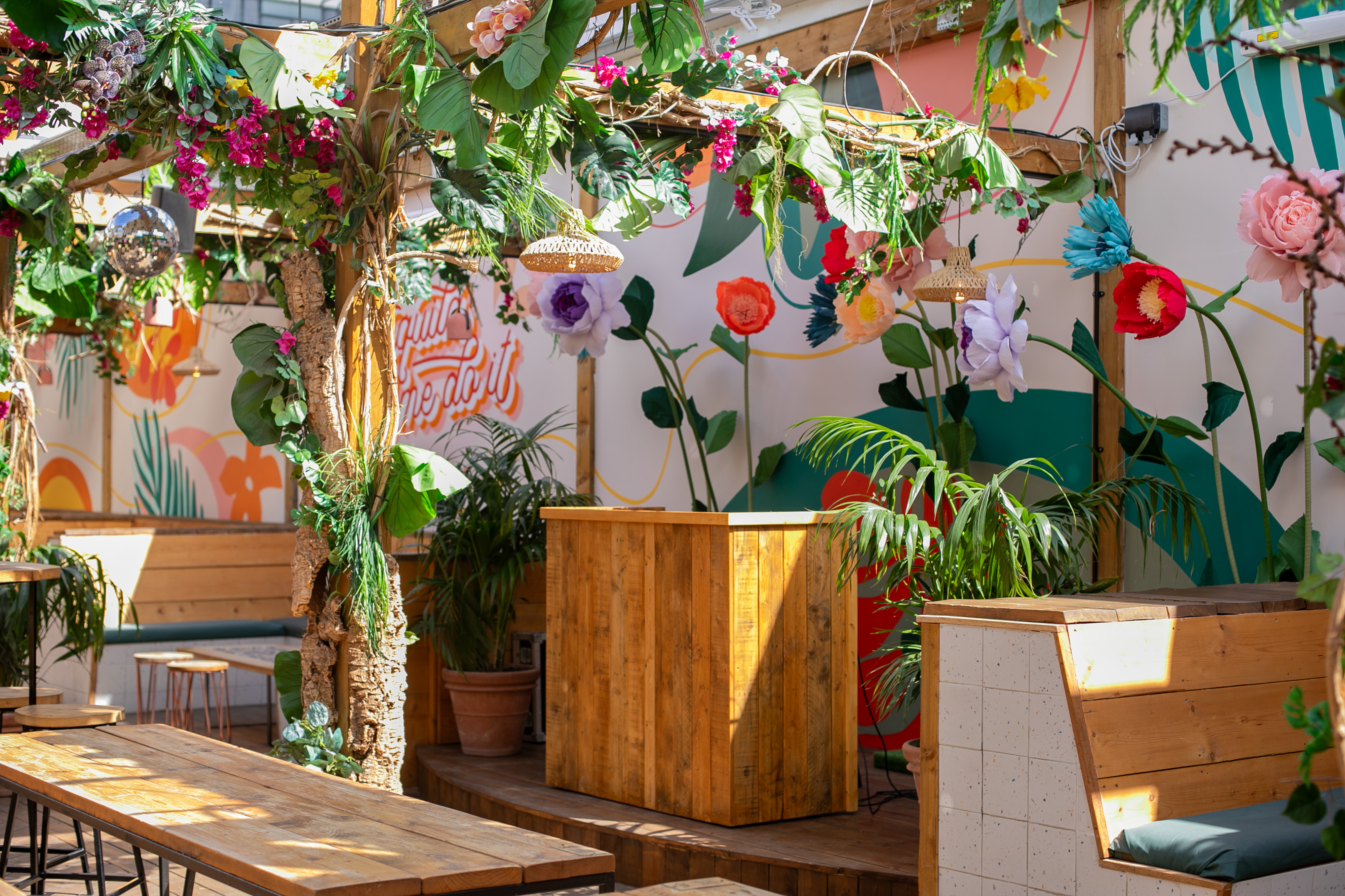 Vibrant event space at Pergola Brixton with lush greenery for gatherings and parties.