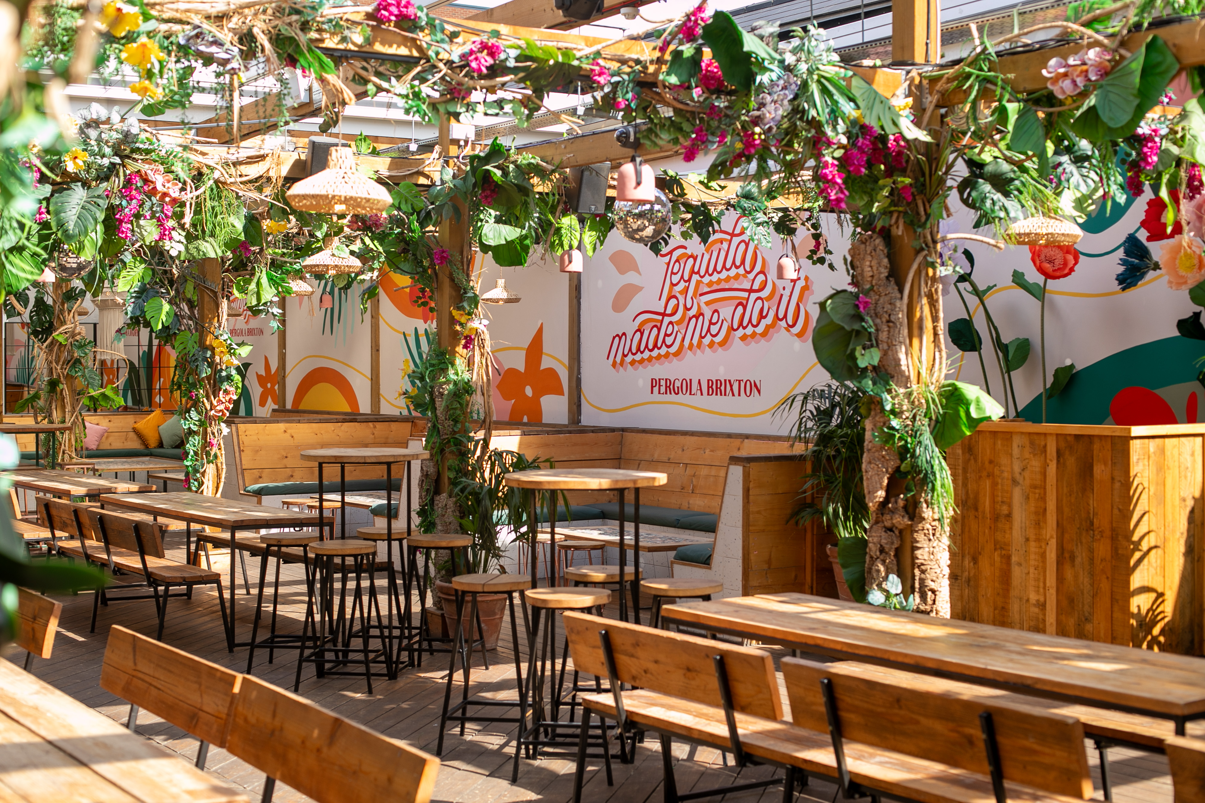 Vibrant event space in Pergola Brixton with lush greenery for gatherings and networking.