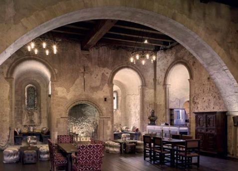 Mansion House at Hedingham Castle: rustic event space with stone walls for gatherings.