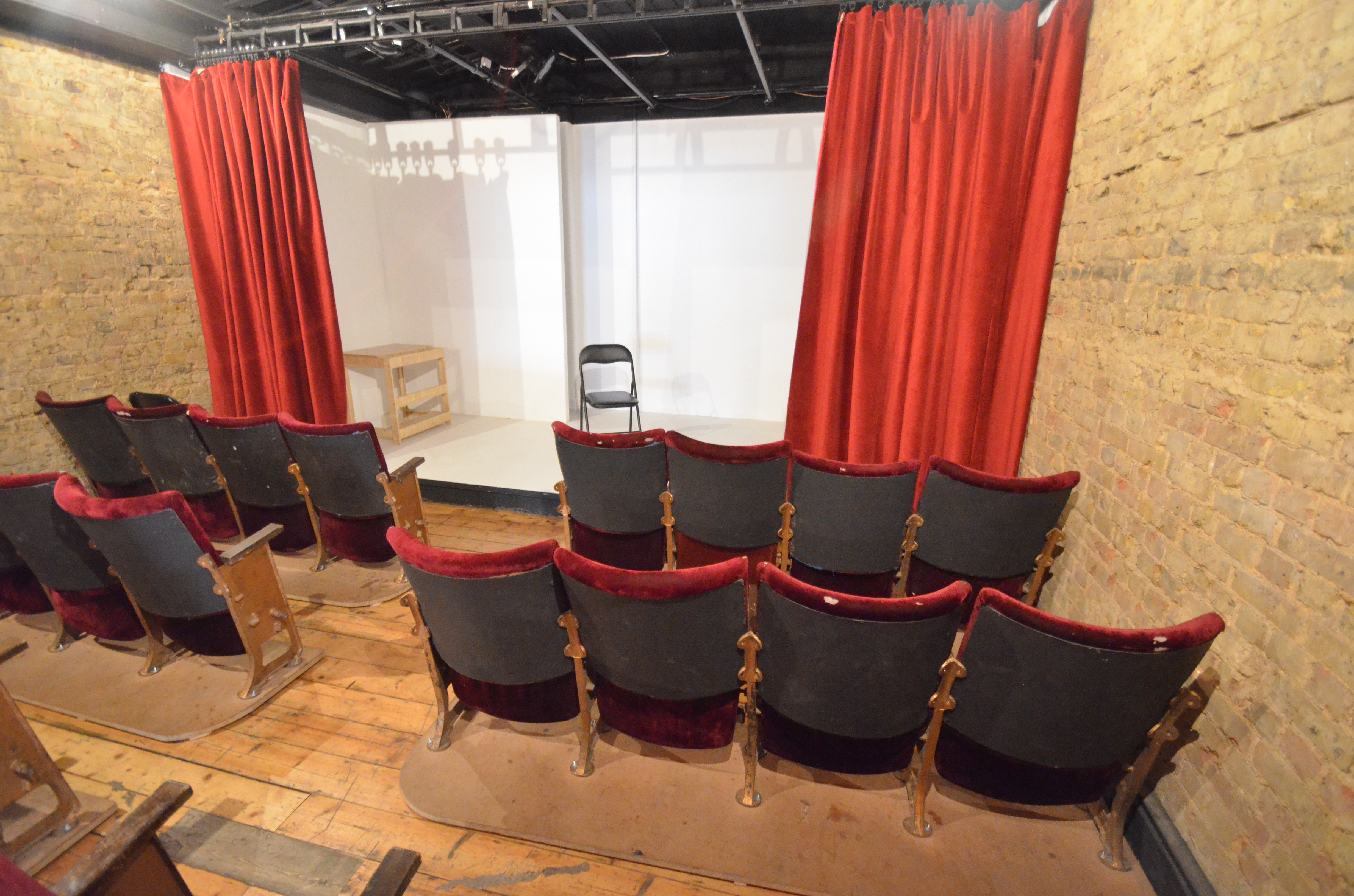Intimate Theatre Space with red curtains for workshops and presentations at Calder Theatre Bookshop.