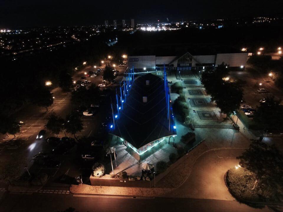 Main Hall in The Ark Royal, illuminated venue for evening events with urban skyline.