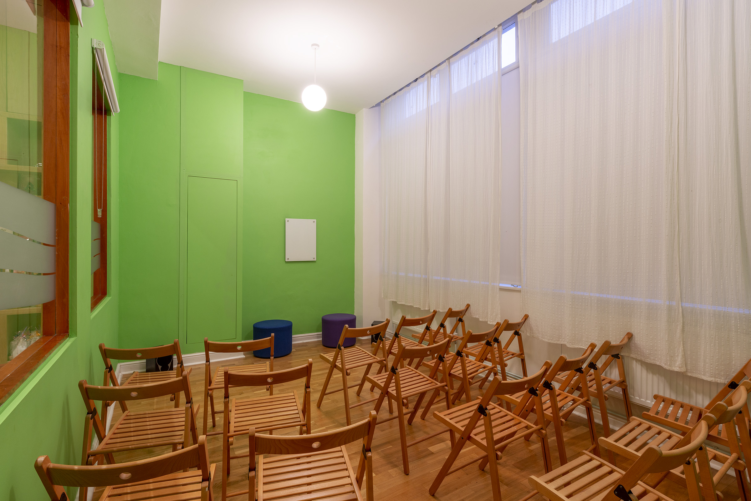 Ganesha studio at Tara Yoga Centre: vibrant green meeting room for workshops.