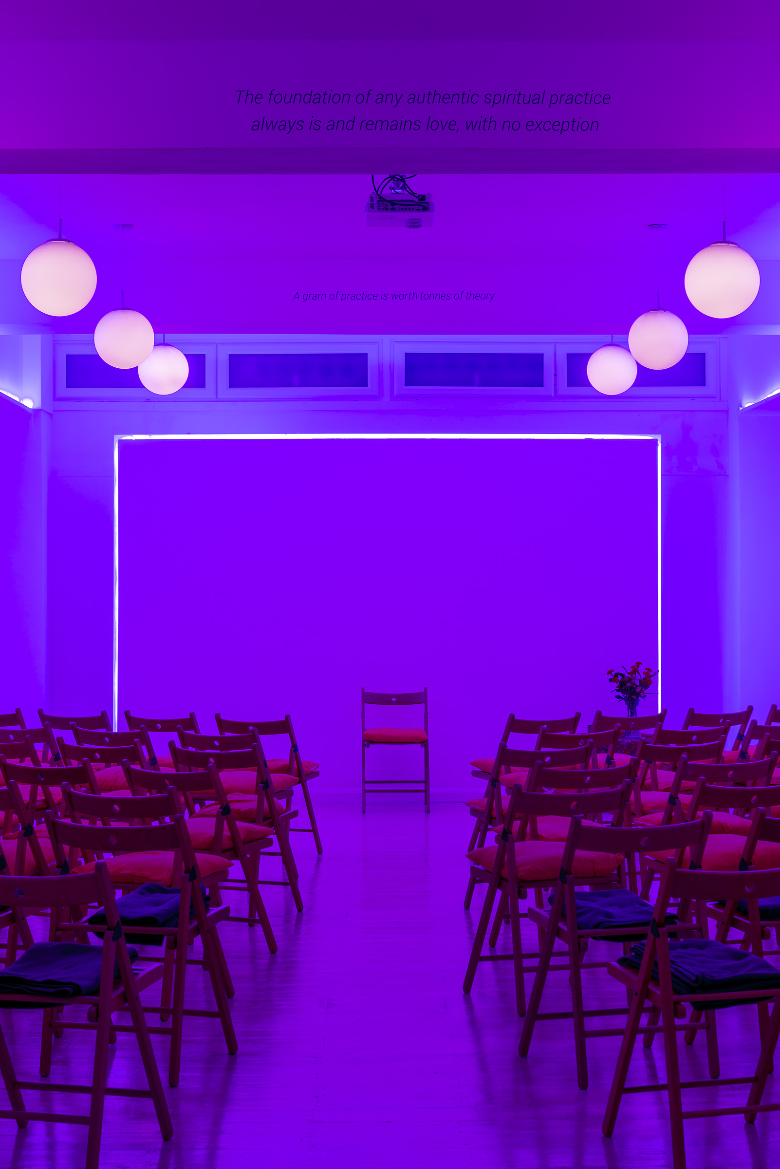 Modern event space at Hridaya Studio with purple lighting for workshops and presentations.