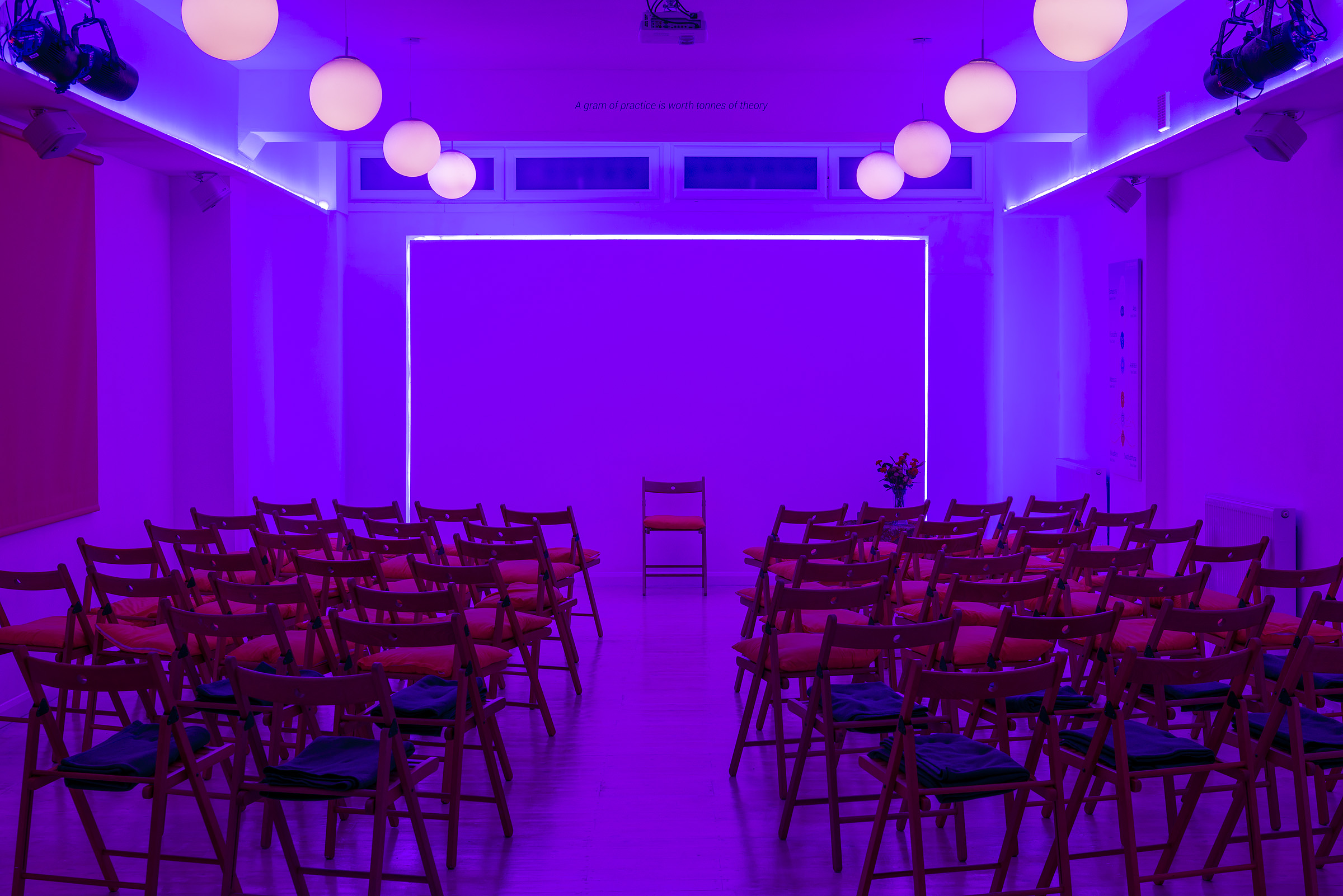 Modern event space at Hridaya Studio with purple lighting for workshops and meetings.