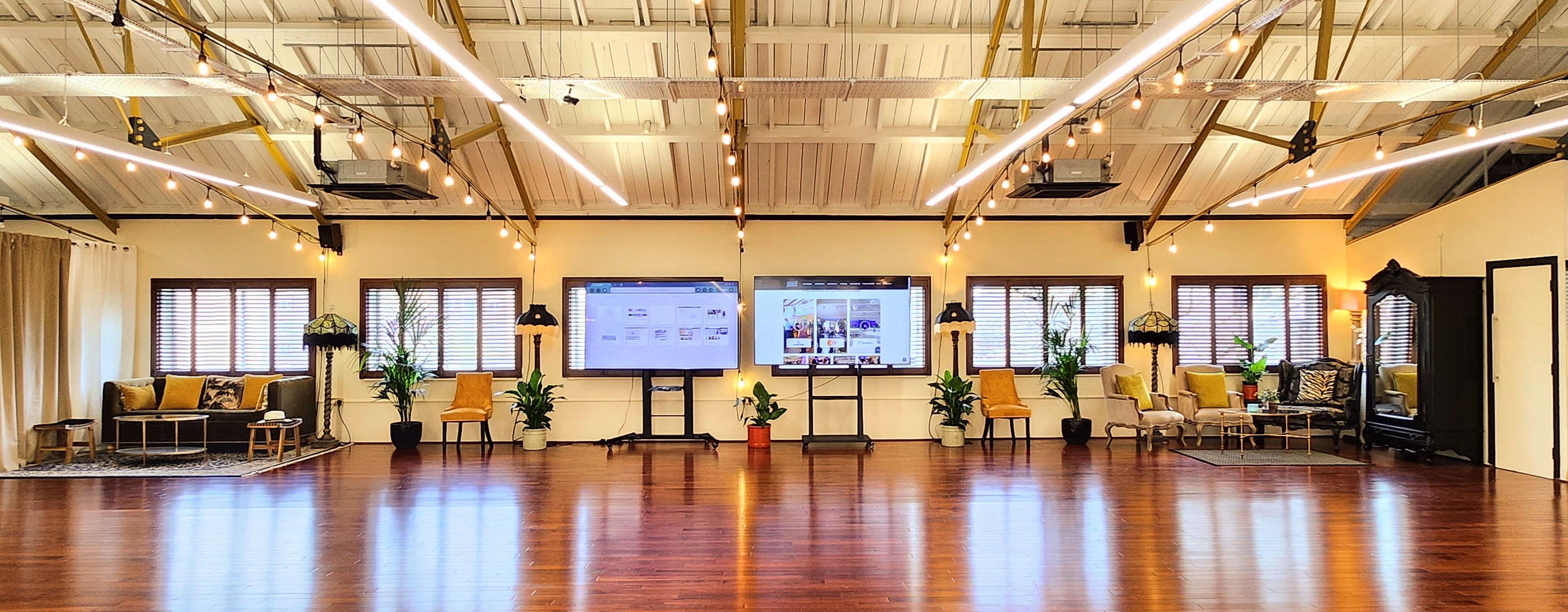 Modern event space with large screens, ideal for meetings and workshops.