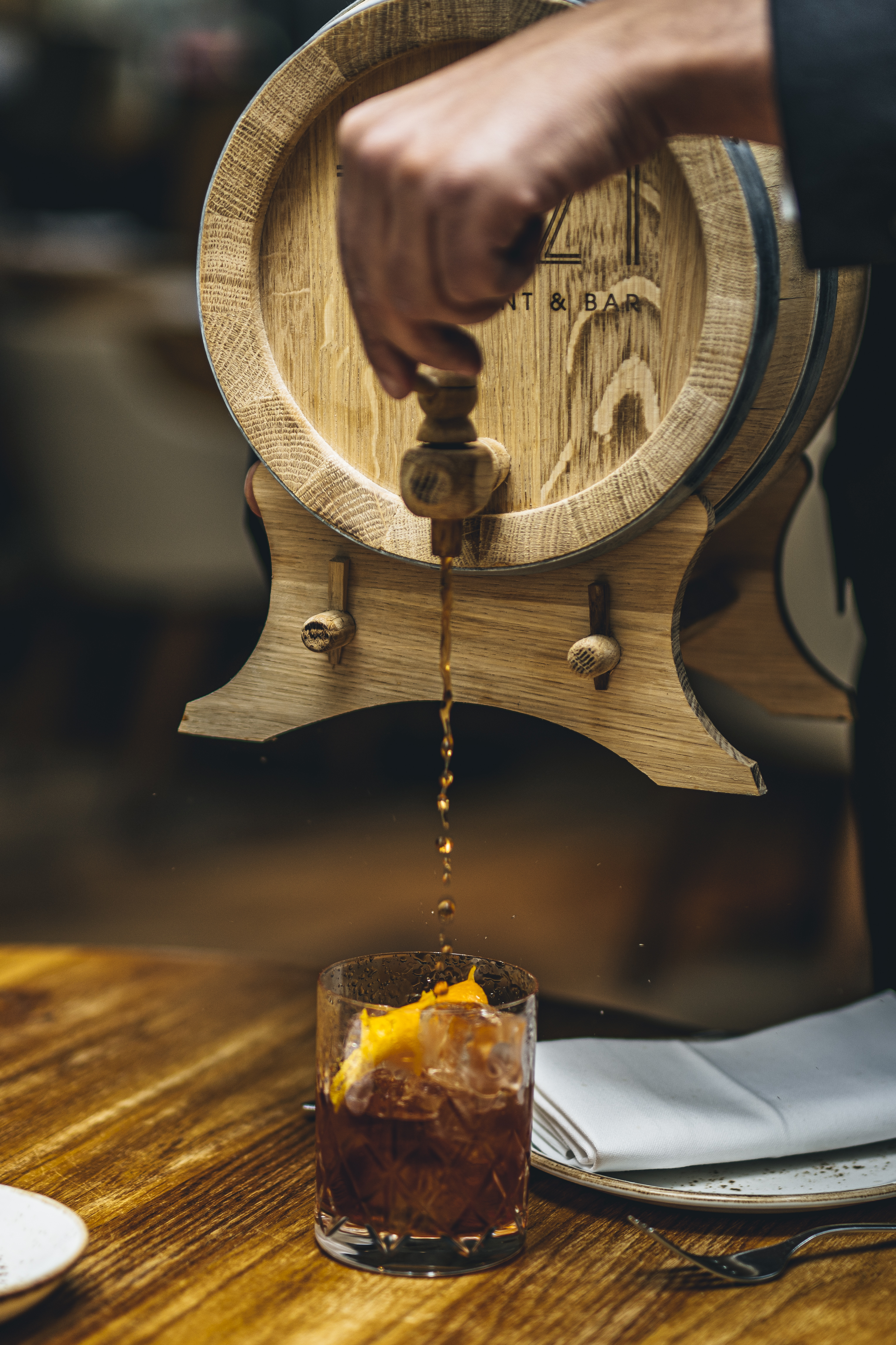 Wooden barrel dispensing craft beverage at TOZI Restaurant & Bar for events and tastings.