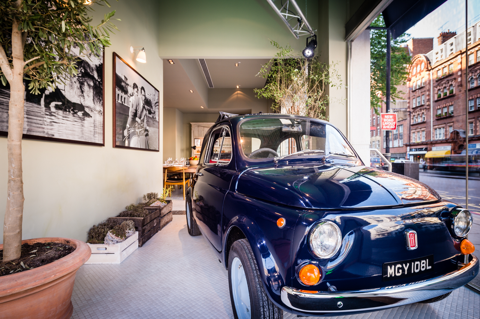 Stylish TOZI Restaurant event space with vintage car, perfect for creative events.