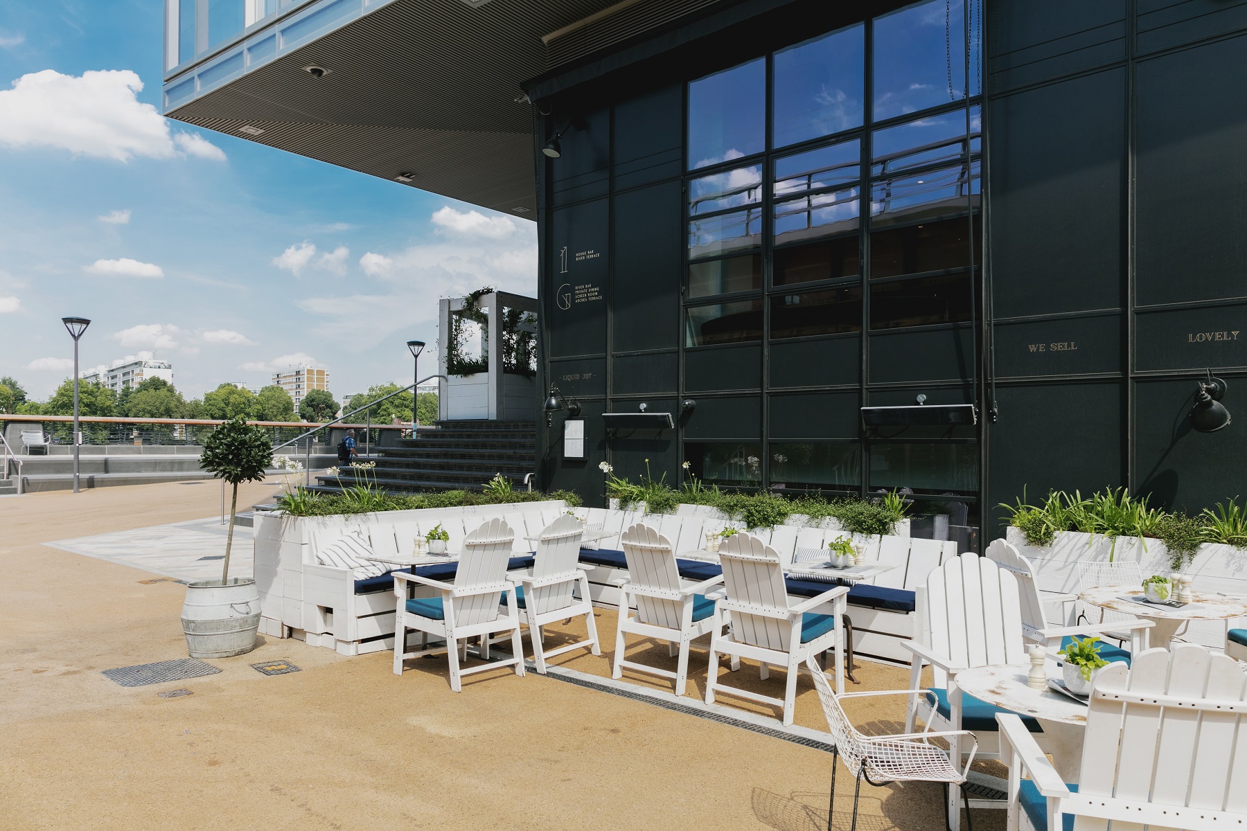 Stylish outdoor event space with white Adirondack chairs at No.29 Power Station West.