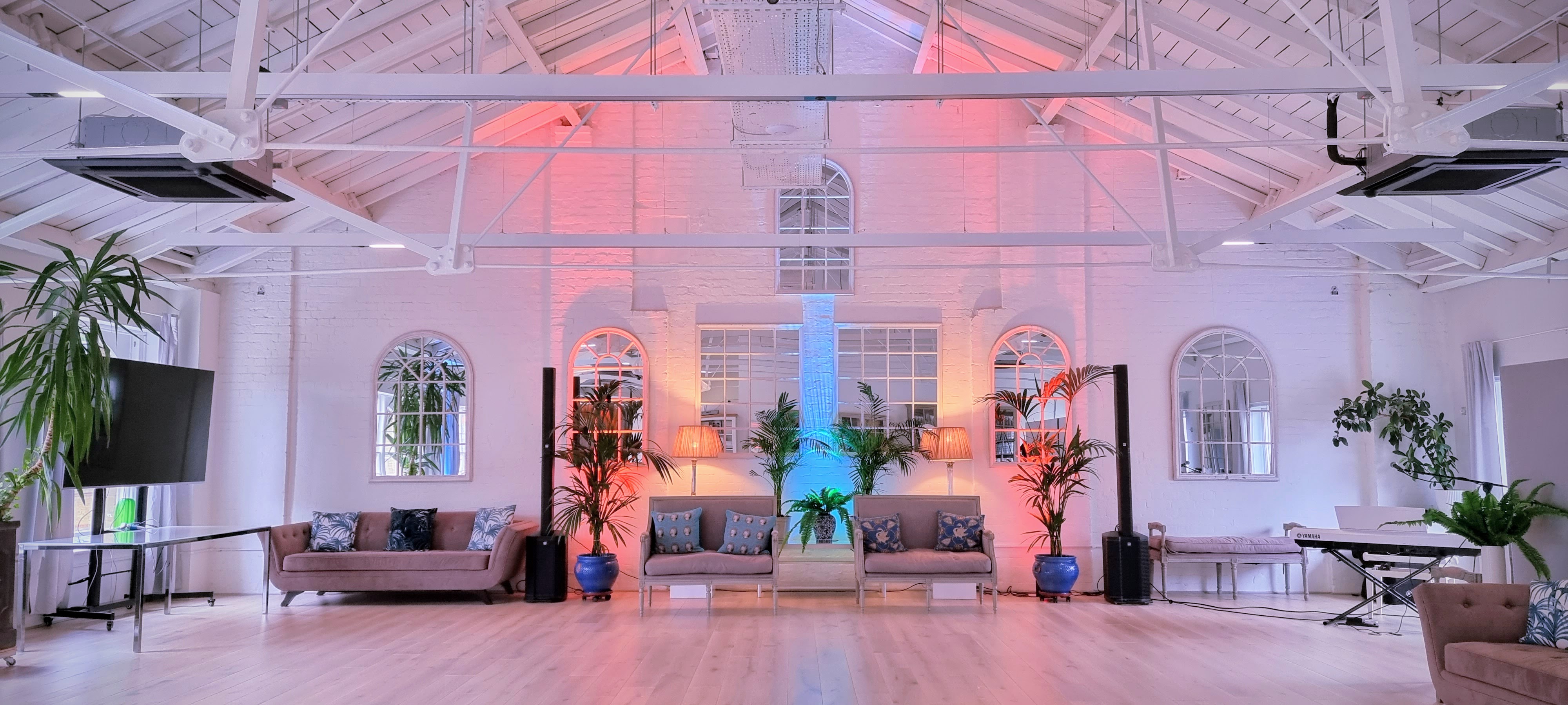 Stylish event space with elegant seating and vibrant lighting for gatherings in Lumiere Underwood.