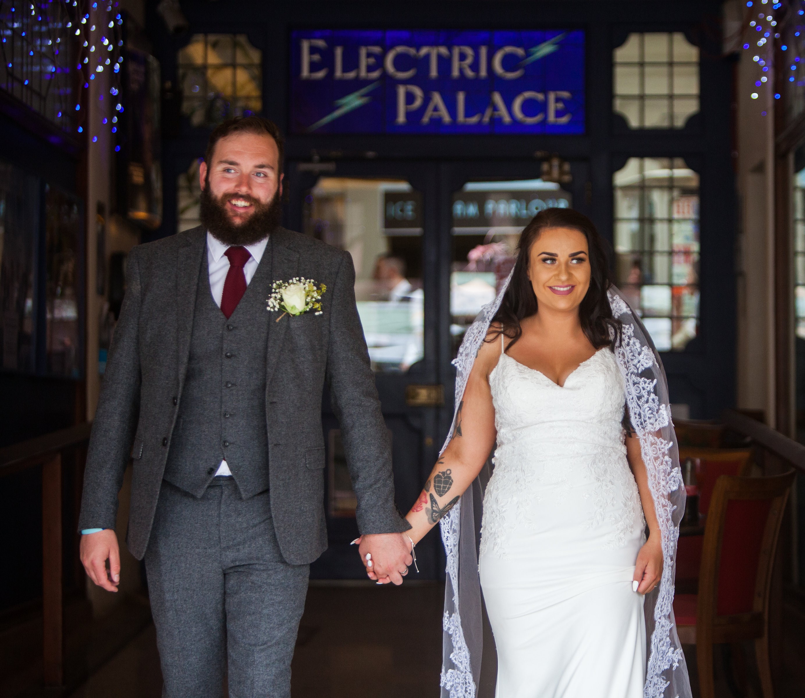 Couple joyfully exiting Bridport Electric Palace, perfect venue for memorable weddings.