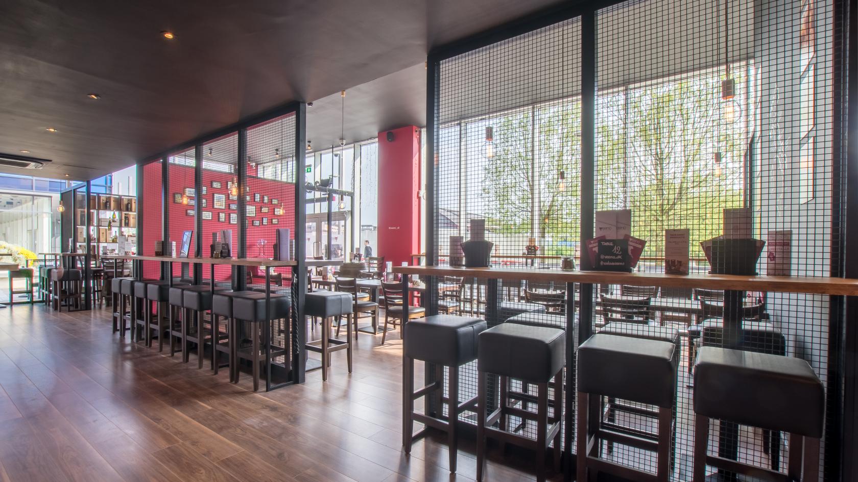 Modern event space with high tables in Veeno Italian Wine Bar, Bristol for corporate gatherings.
