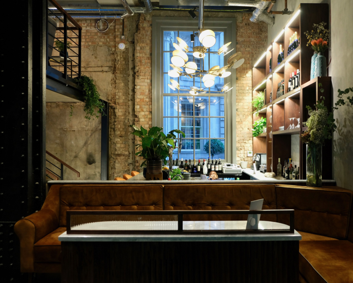 Stylish exclusive venue with natural light, perfect for intimate networking events.