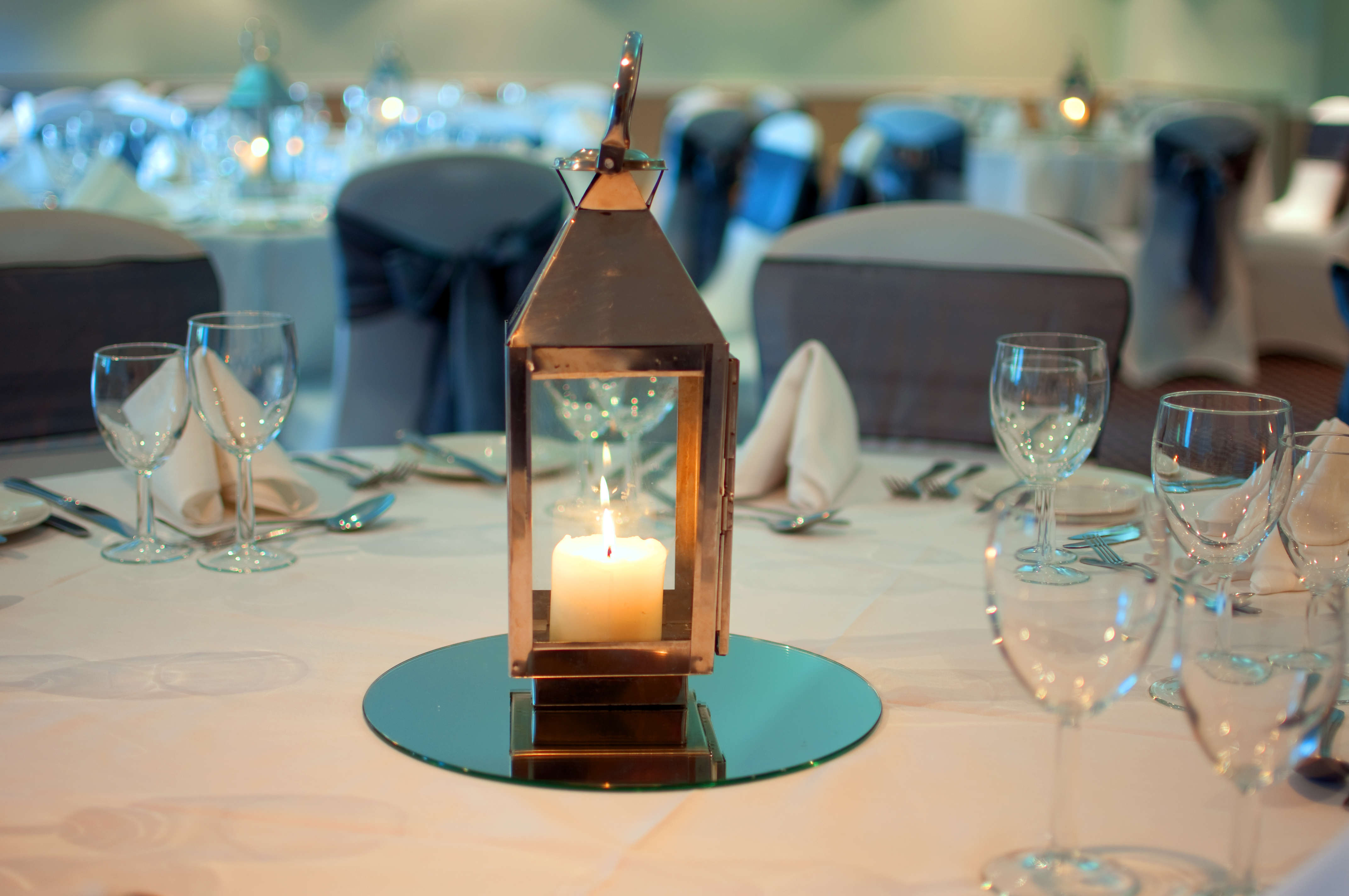 Elegant dining table with lantern centerpiece at Bridgewood Manor Hotel & Spa for events.