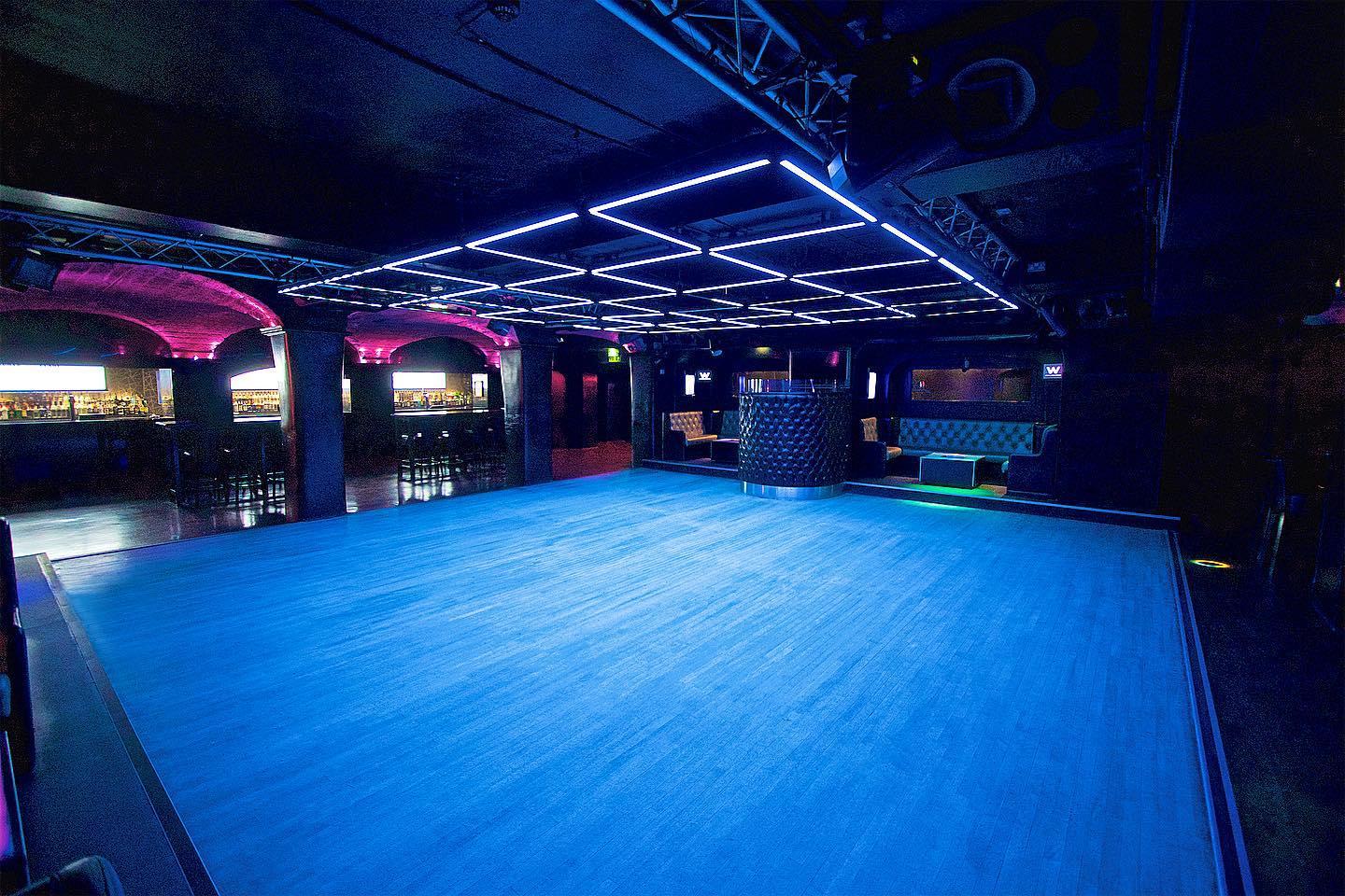 Versatile event space at Why Not Nightclub with modern design and dynamic lighting.