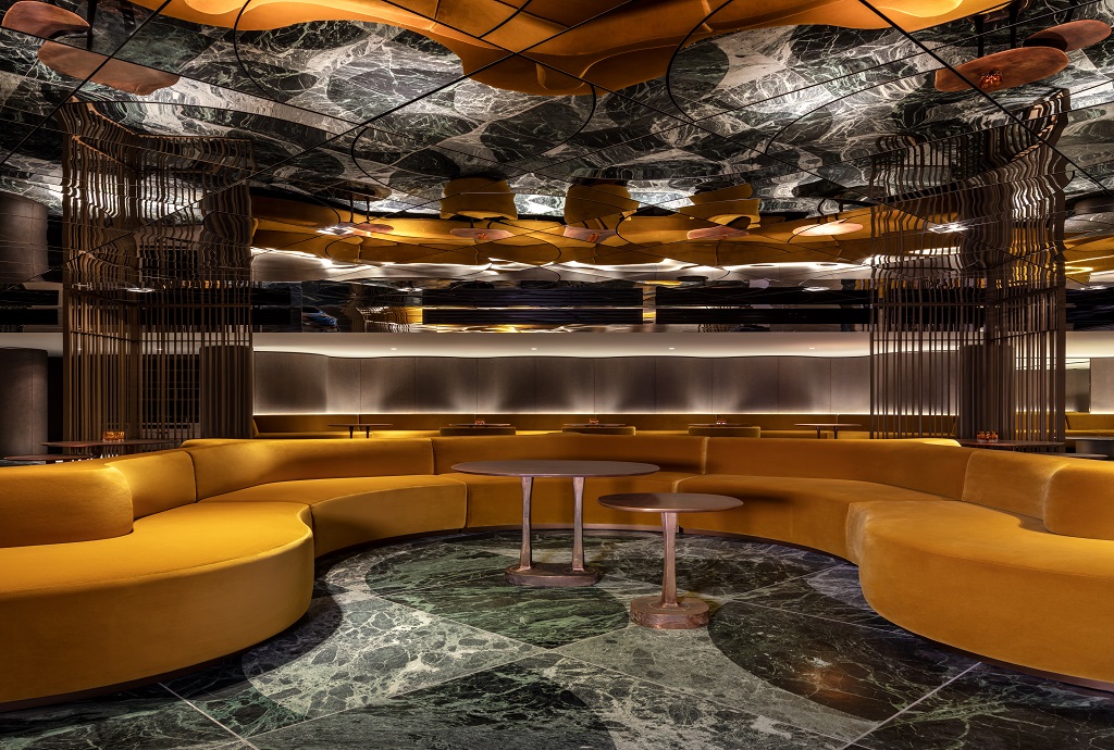 Elegant event space with curved seating and marble floor at The Londoner's Green Room.