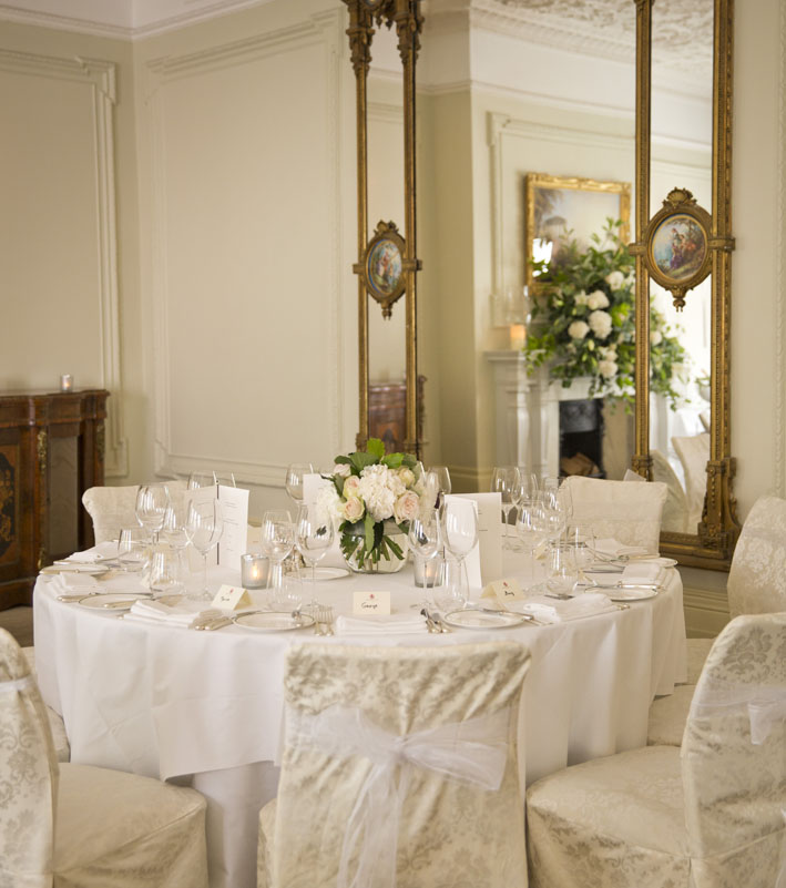 Elegant round table setup in The Roosevelt Room for formal dinners and upscale events.