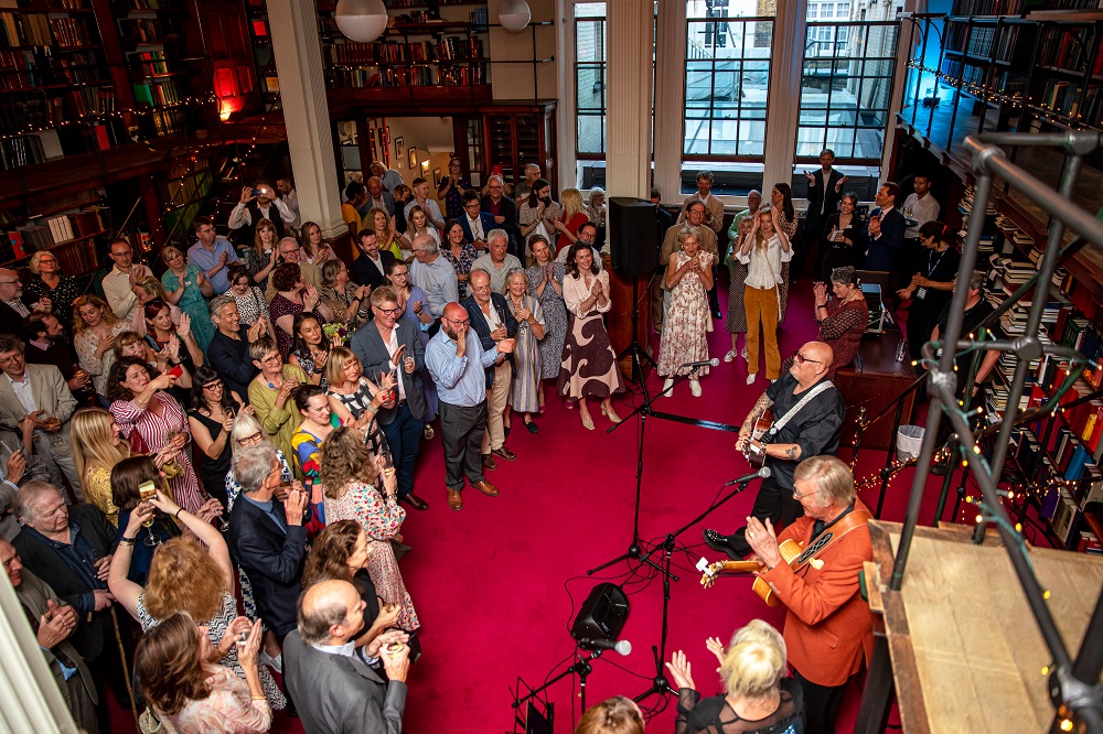 Vibrant event at The London Library with elegant decor and live music for networking.