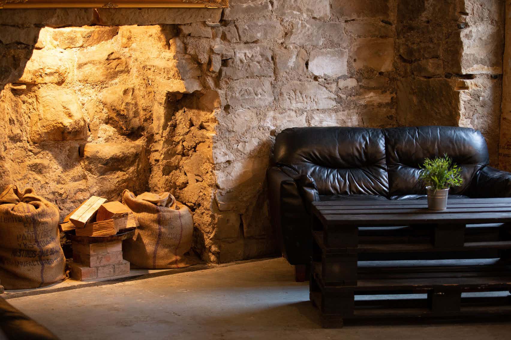 Cozy rustic meeting space with leather couch for private venue hire events.
