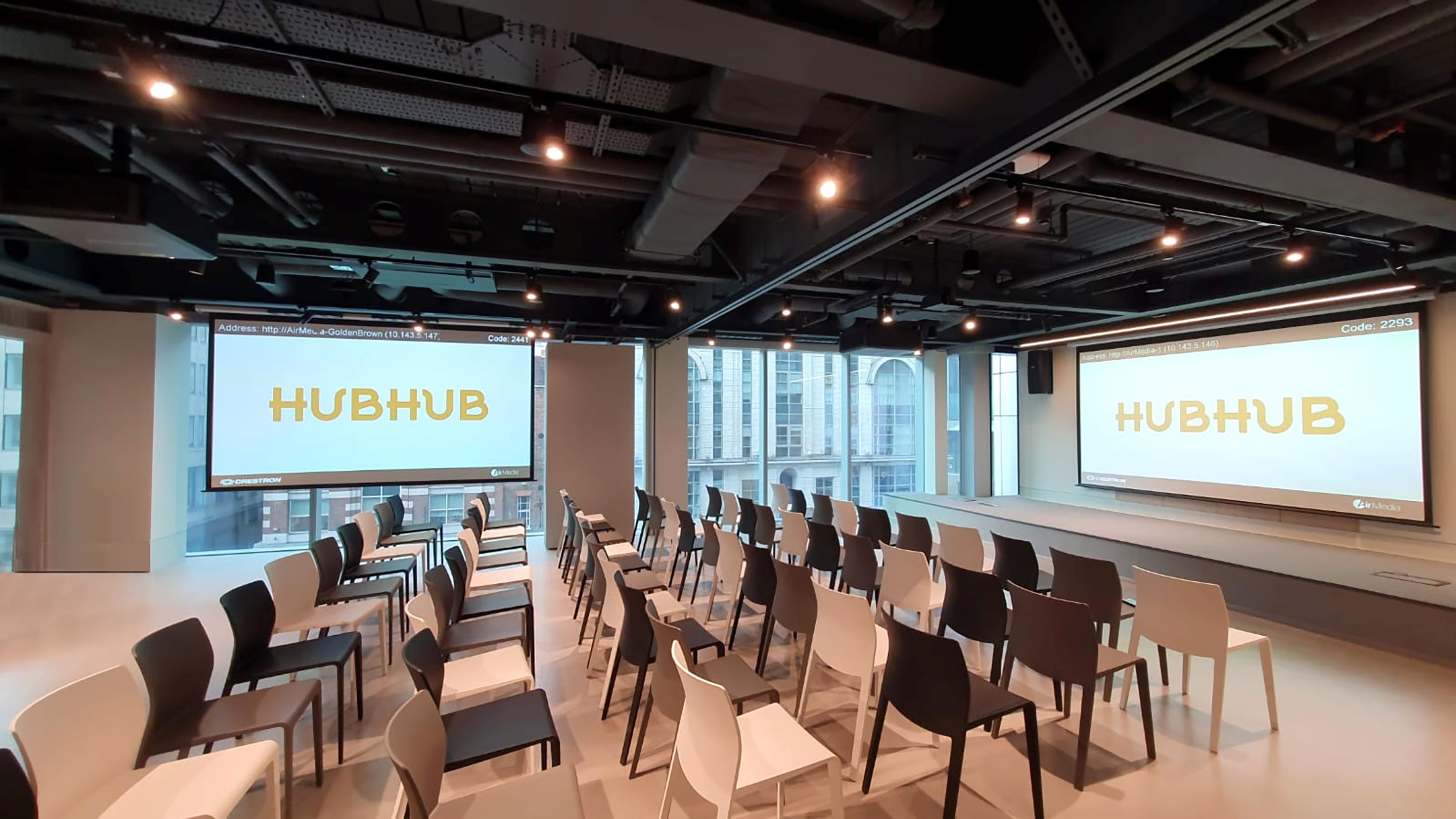 Modern business lounge event space with sleek chairs for presentations at HubHub.
