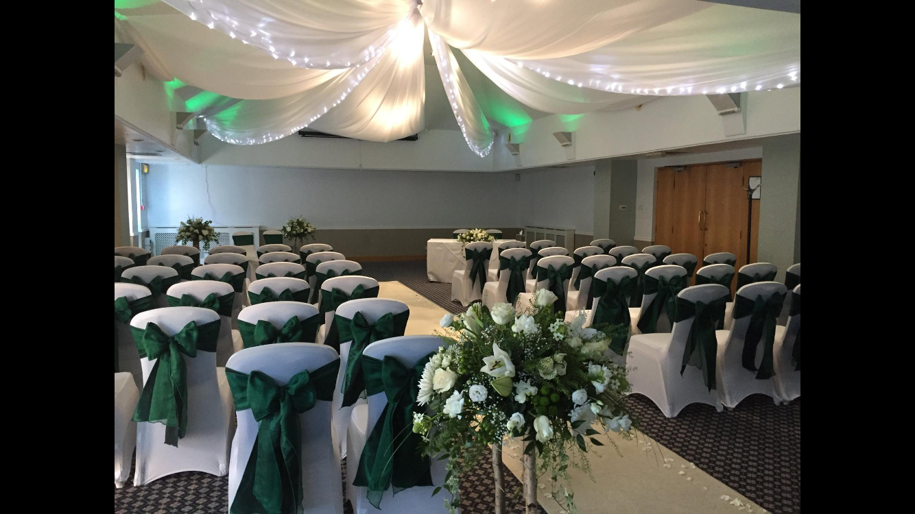 Hogarth Suite at Bridgewood Manor Hotel, elegant wedding venue with floral centerpiece.