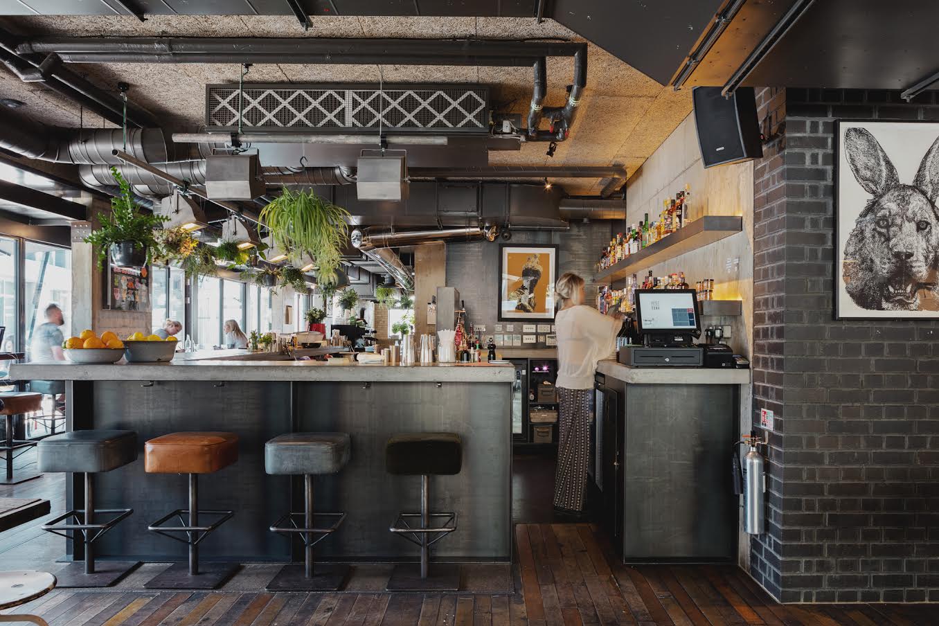 Modern bar venue with industrial design, ideal for networking events and gatherings.