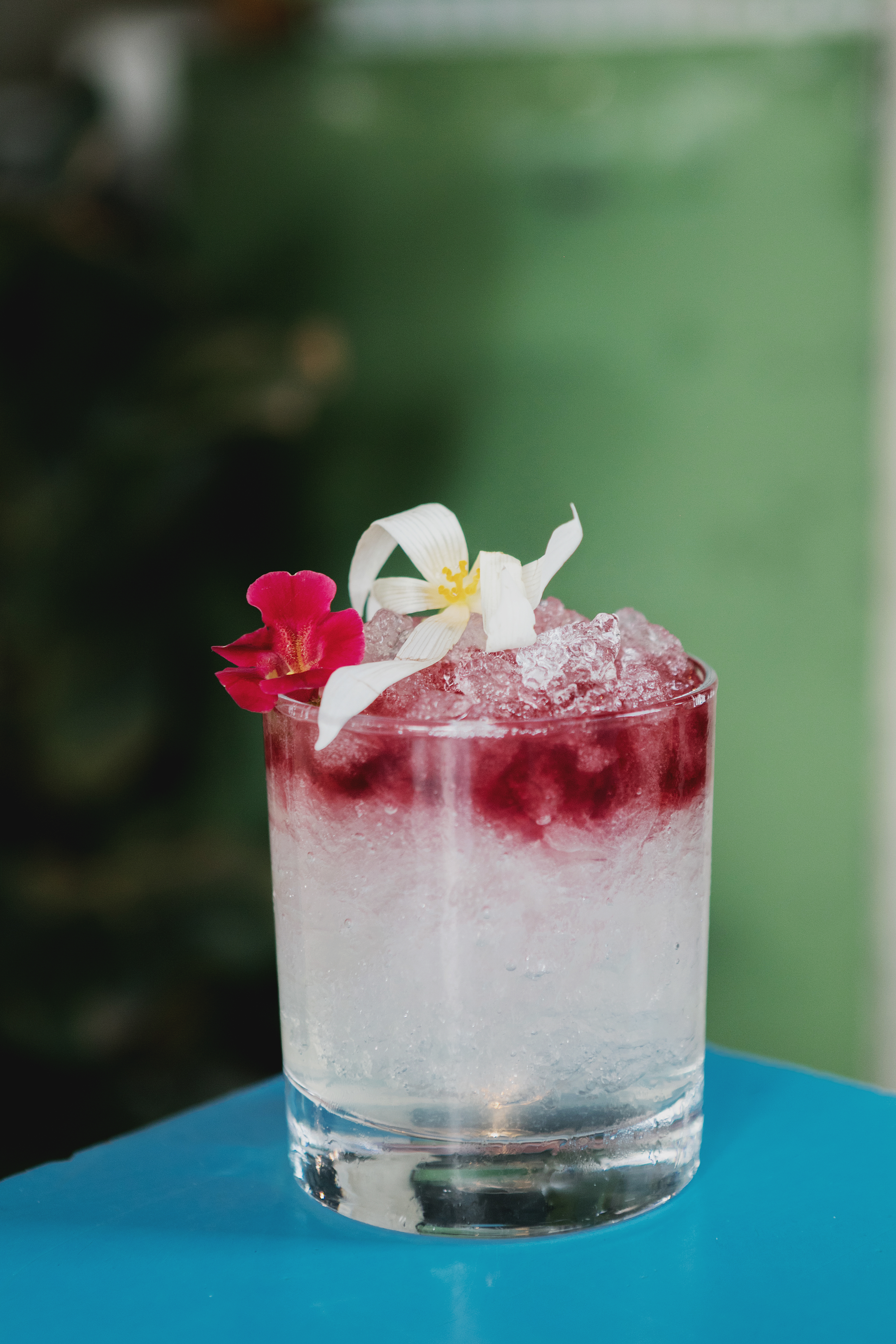 Cocktail garnished with flowers at Heist Bank, ideal for upscale events and gatherings.