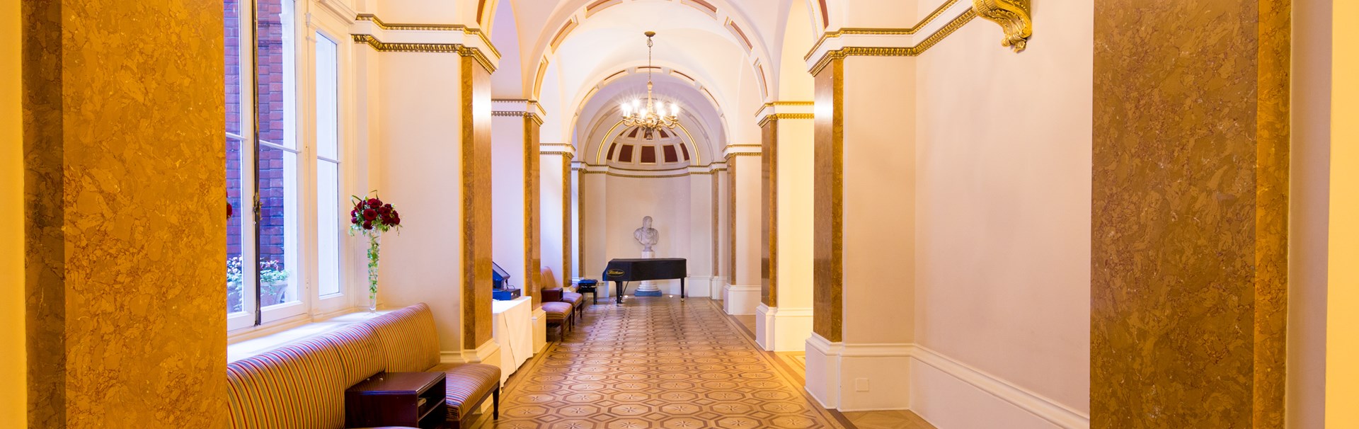 Elegant ballroom with arched ceilings, perfect for upscale receptions and events.