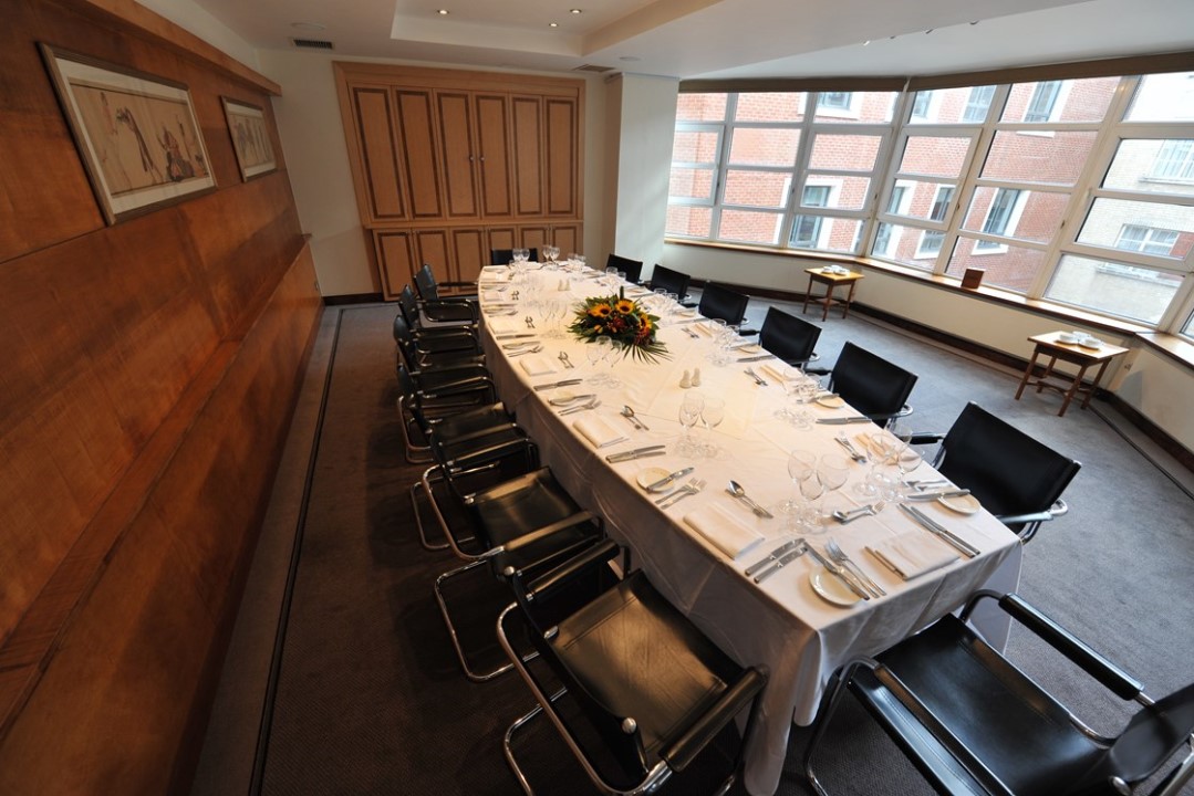 Elegant ballroom with oval table, ideal for corporate meetings and events.