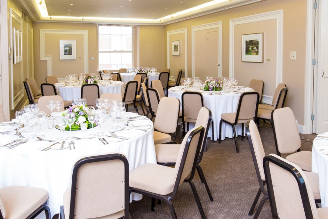 Elegant ballroom setup with round tables for professional gatherings or celebrations.