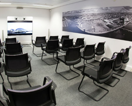 Atrium meeting room in Glasgow Science Centre, modern setup for presentations and workshops.