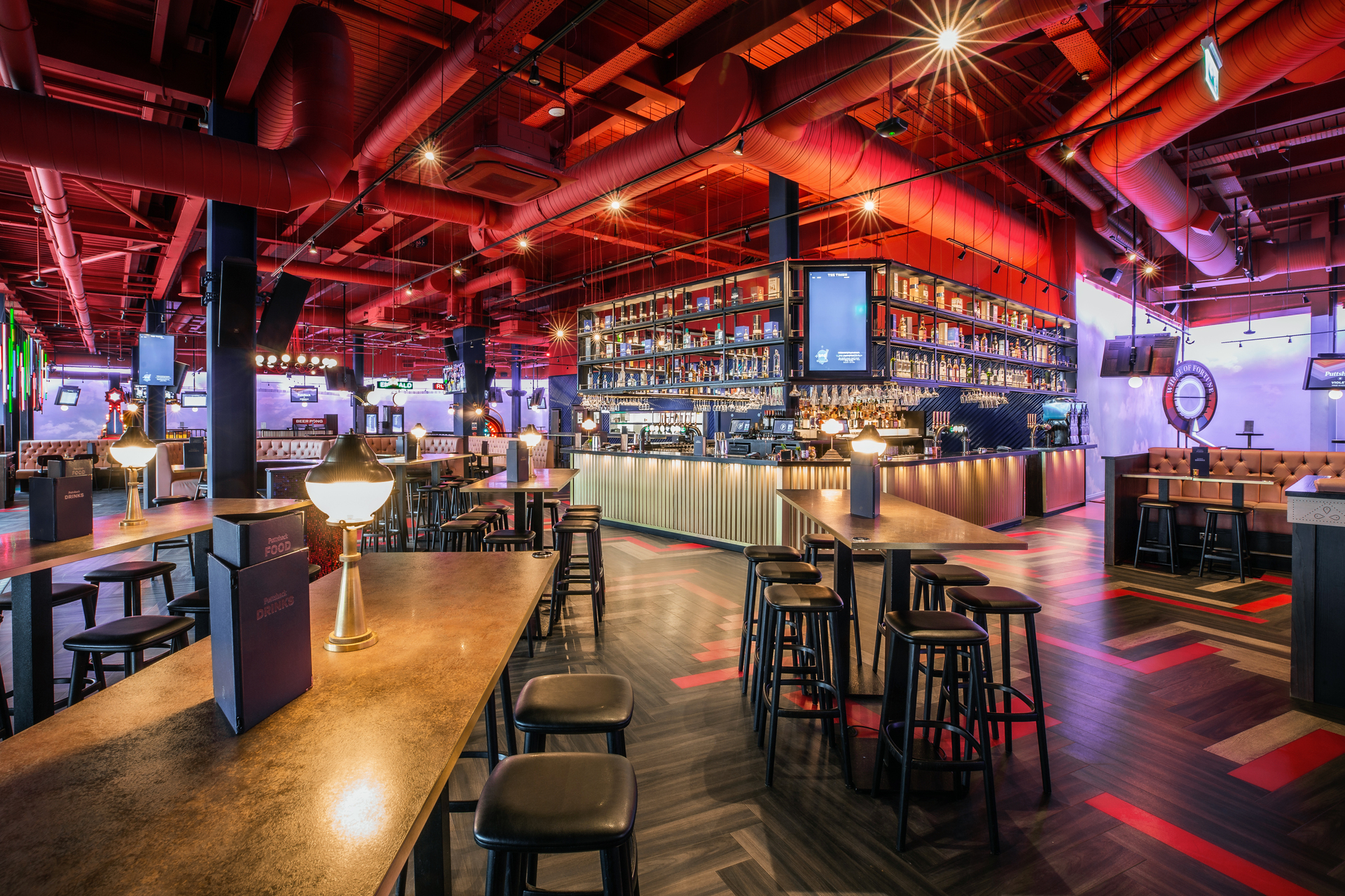 Vibrant event space with modern bar for social gatherings at Puttshack Lakeside.