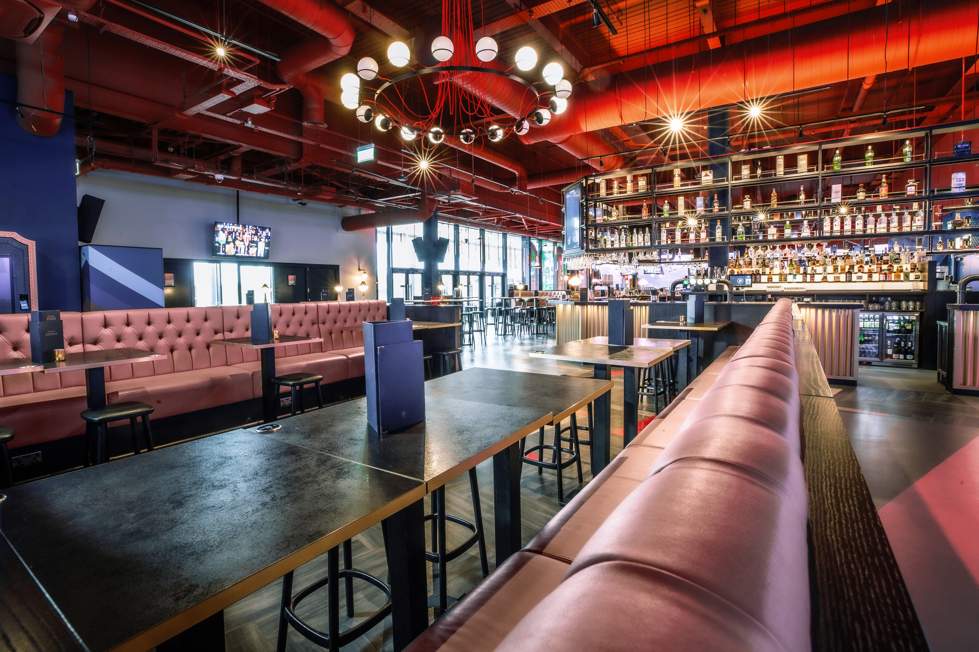 Modern event venue with stylish decor and vibrant bar at Puttshack Lakeside.