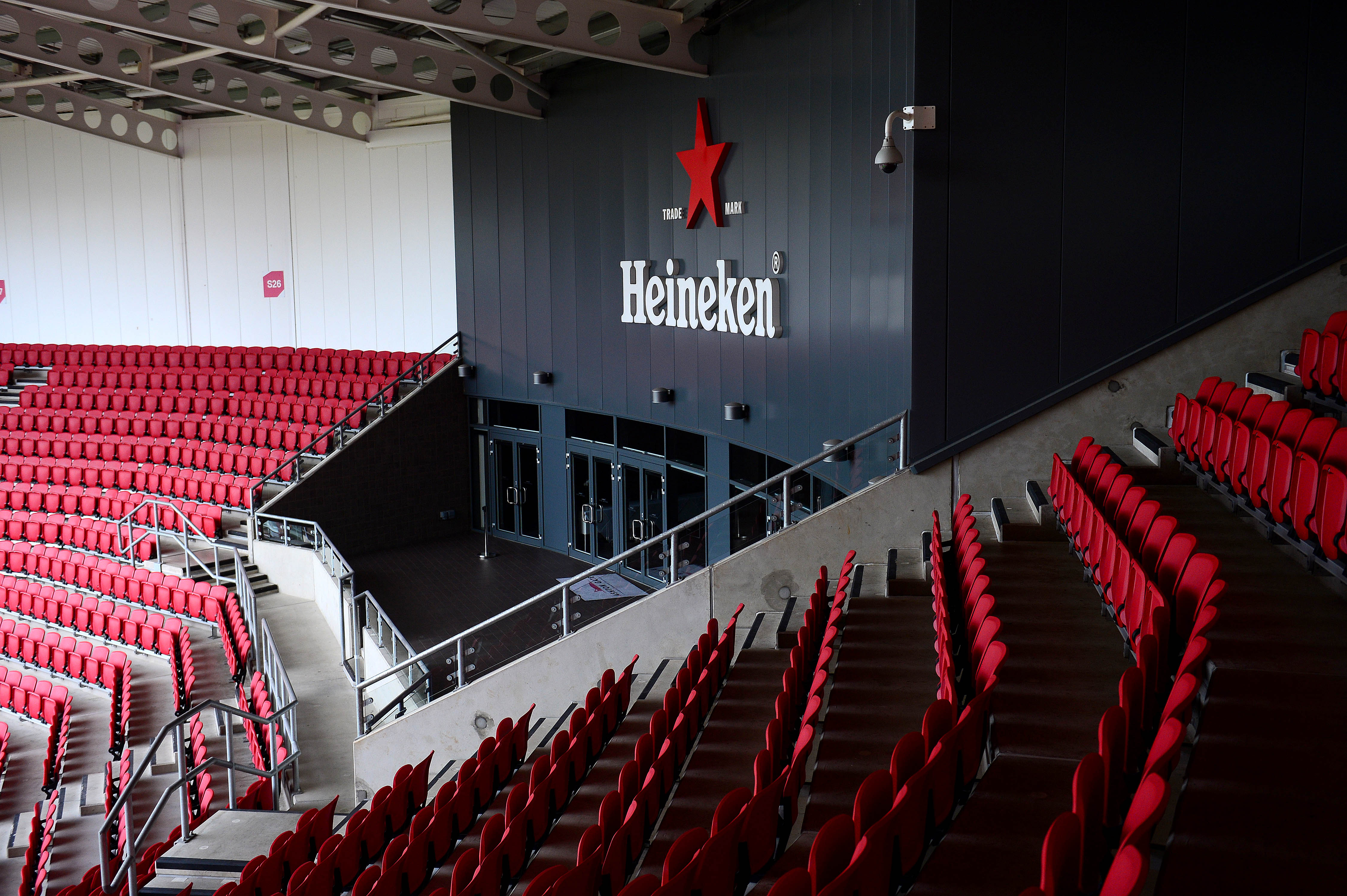Heineken Suite at Ashton Gate Stadium with red seating for corporate events and gatherings.