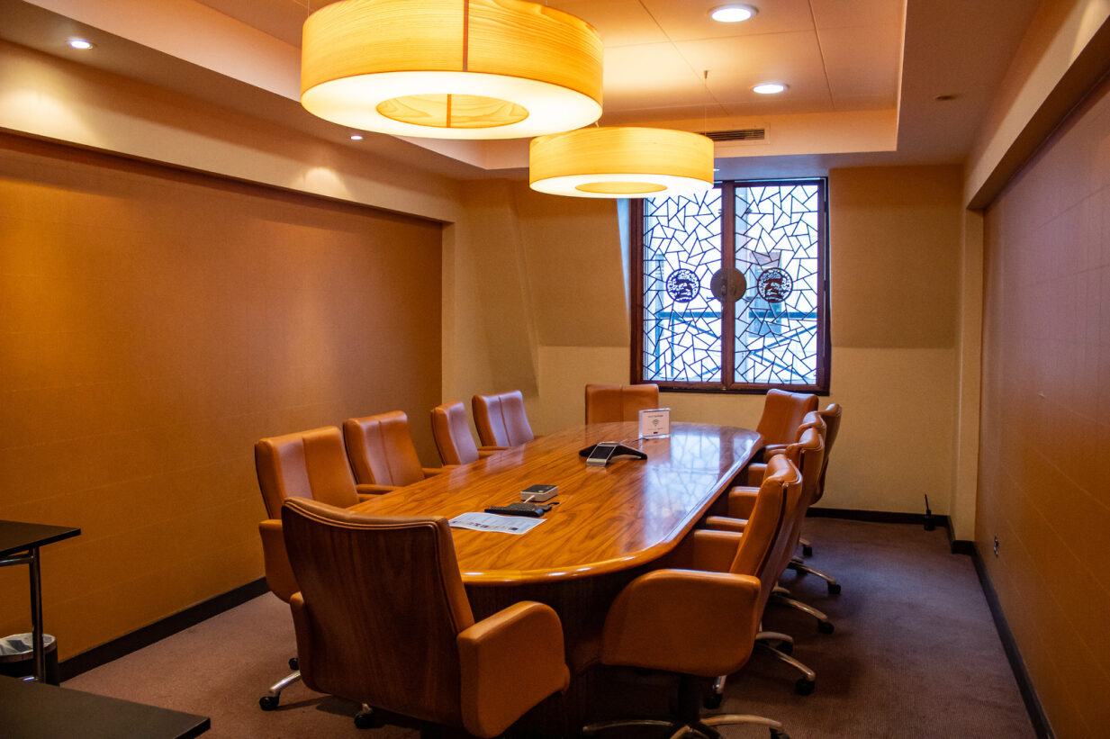 CUHK meeting room with wooden table, ideal for professional gatherings and presentations.