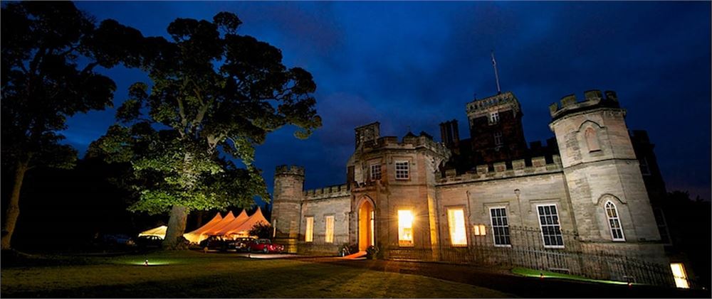 Winton Castle venue with glowing windows, perfect for weddings and corporate events.