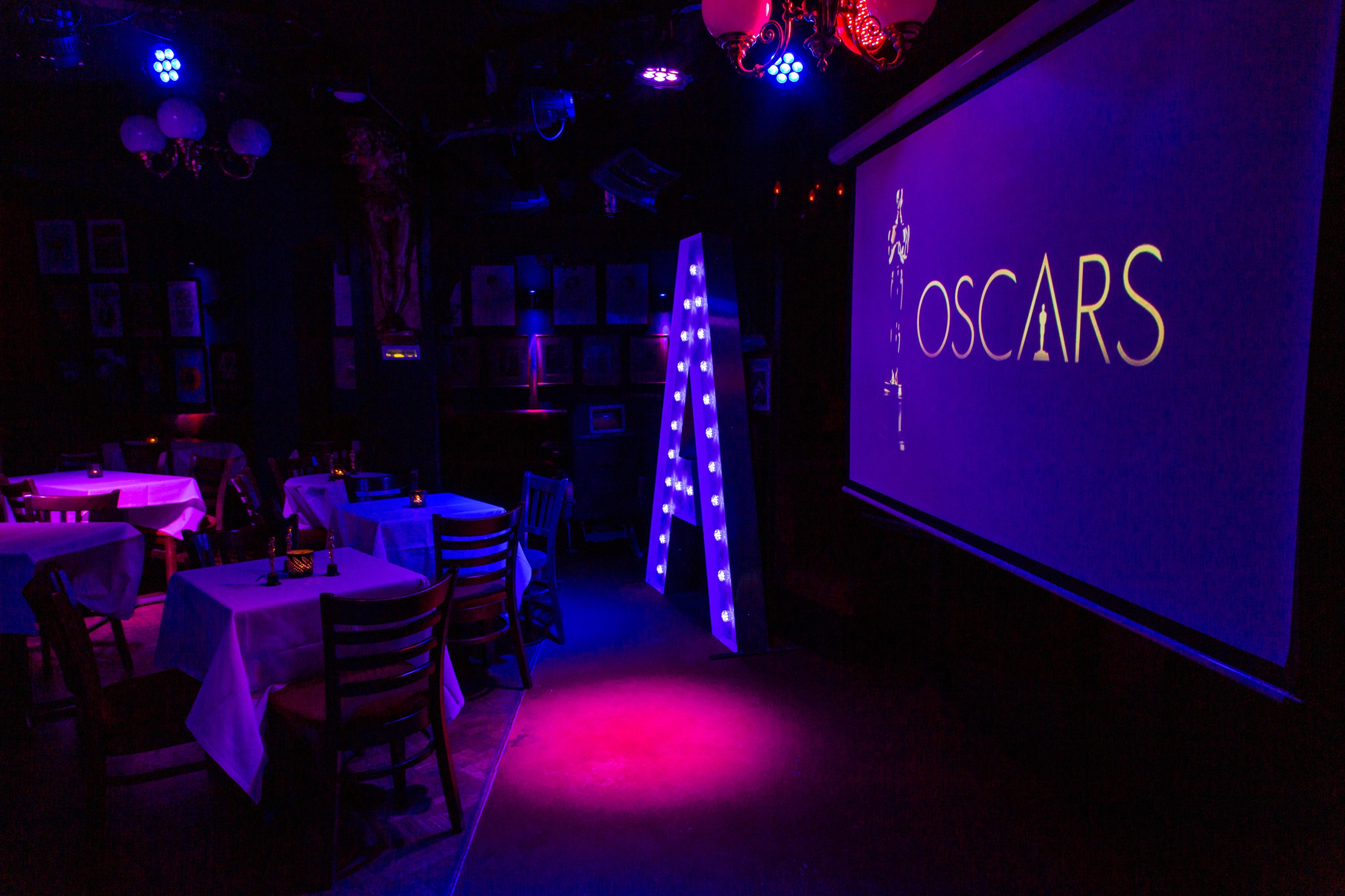 Oscars-themed event space in Phoenix Arts Club with elegant tables and glamorous decor.