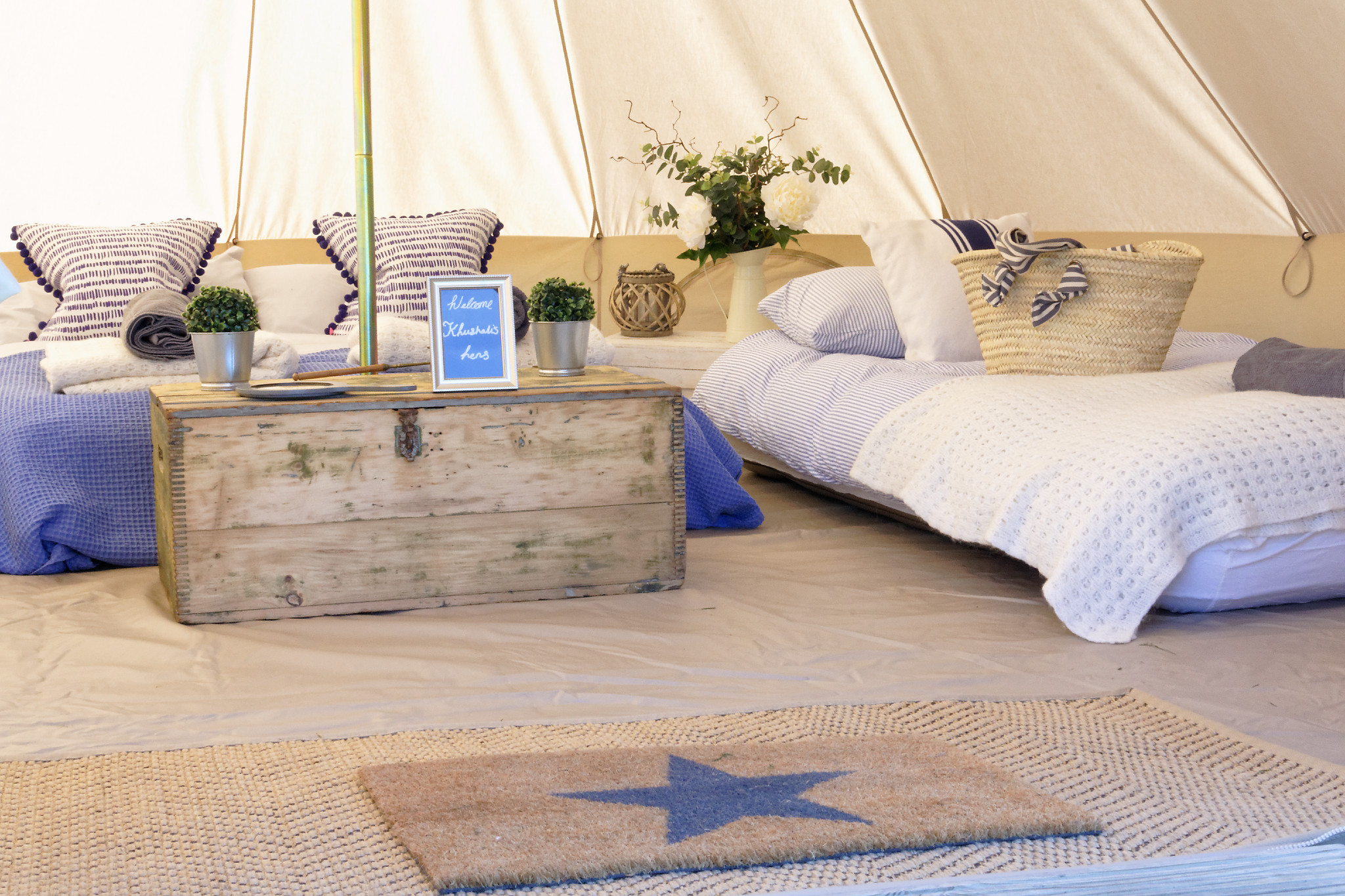 Cozy glamping setup with inviting beds for unique retreats and team-building events.