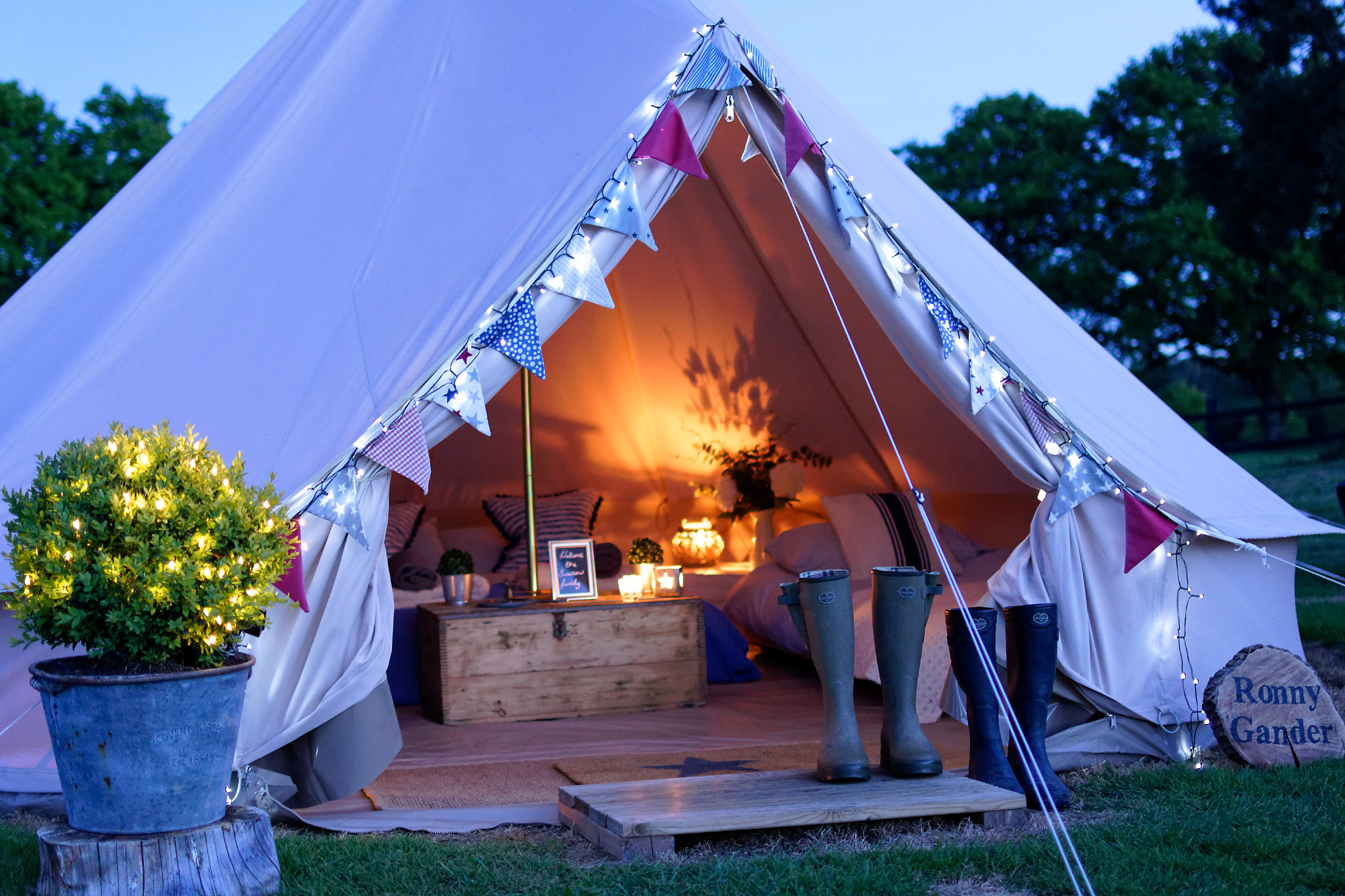 Cozy glamping tent with fairy lights for outdoor events and gatherings.