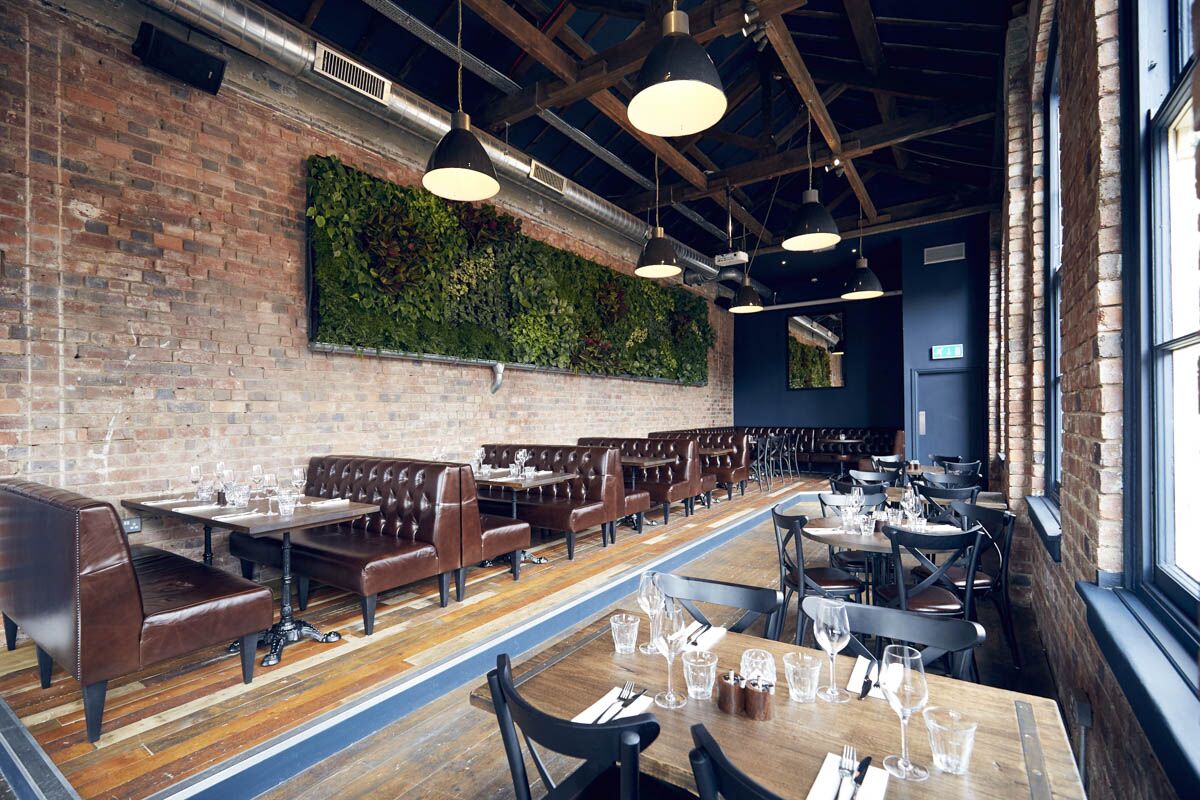 Stylish event space with exposed brick and leather seating, ideal for networking events.
