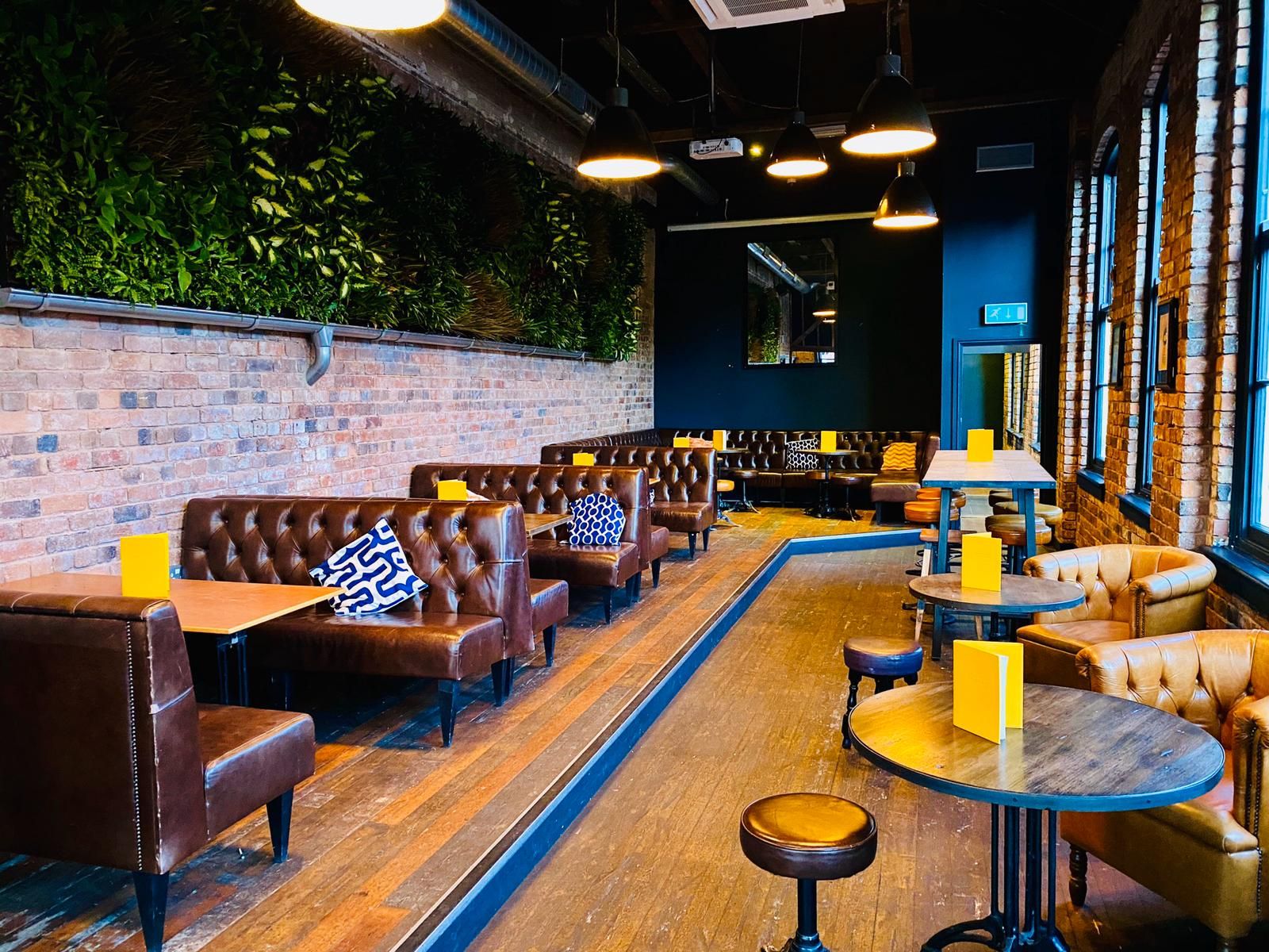 Stylish venue with leather seating and greenery for events at The Button Factory.